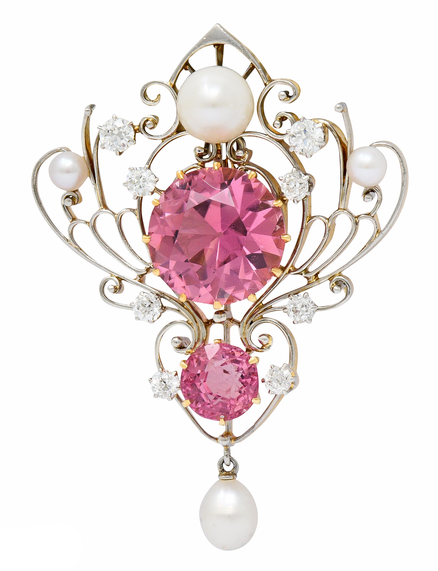 Pendant is designed as intricate filigree that centers two round cut pink tourmaline; 13.0 mm and 7.0 mm

With old European cut and transitional cut diamonds weighing approximately 0.50 carat; G/H color with VS and SI clarity

Accented by three