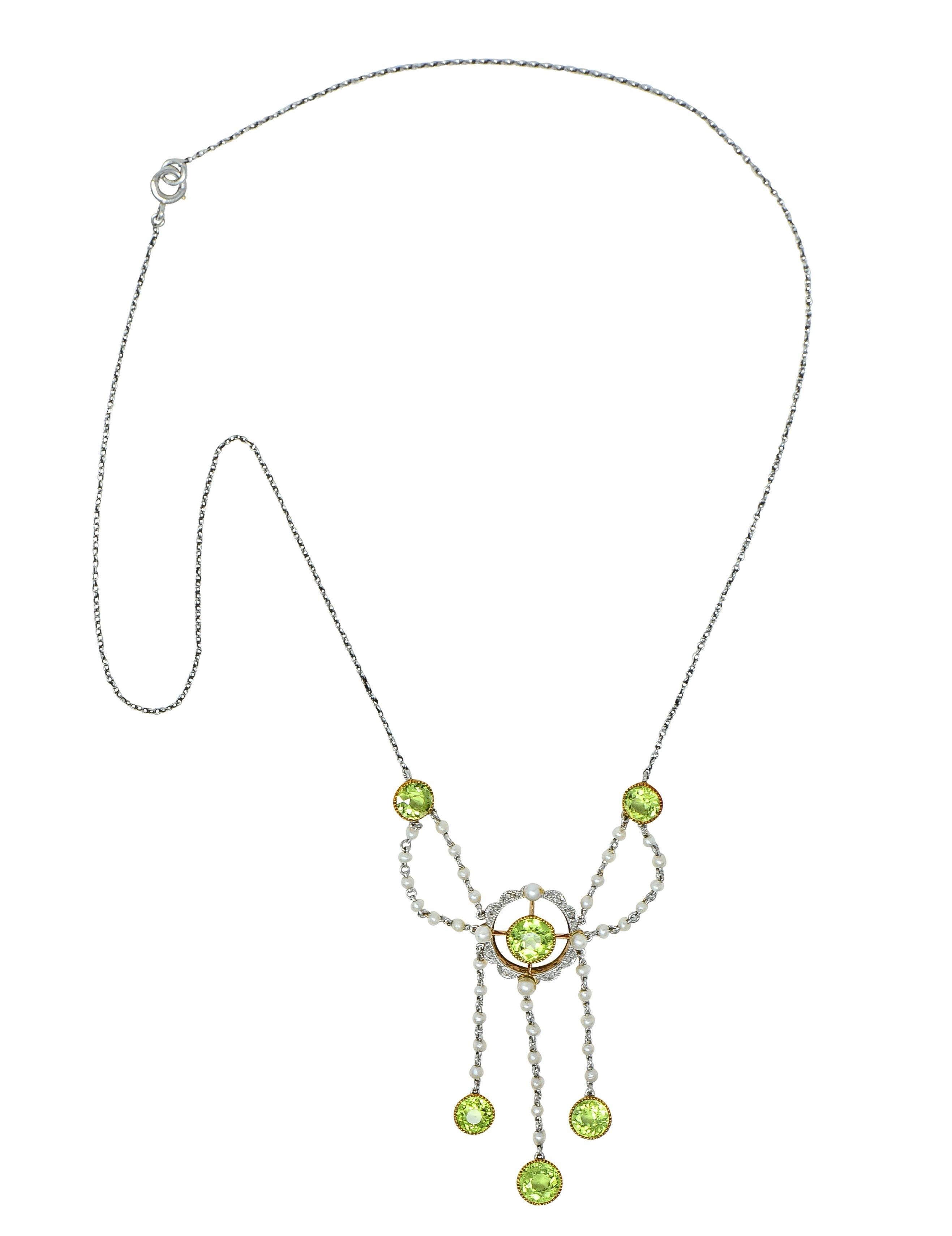 Designed as a 1.0 mm cable link chain with swagged fringe station featuring round cut peridot 
Ranging in size from 4.5 to 5.5 mm - transparent medium yellowish green in color
Set across top of station and fringe in yellow gold milgrain bezels
With