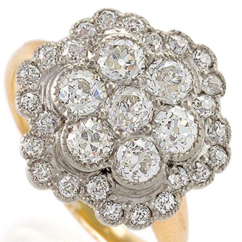 An Edwardian platinum and 14 karat gold ring with diamonds. The ring has 31 old European-cut diamonds with an approximate total weight of 1.35 carats. The ring is designed in a cluster motif. The ring shank is later. Circa 1910.

Ring size 4-3/4;