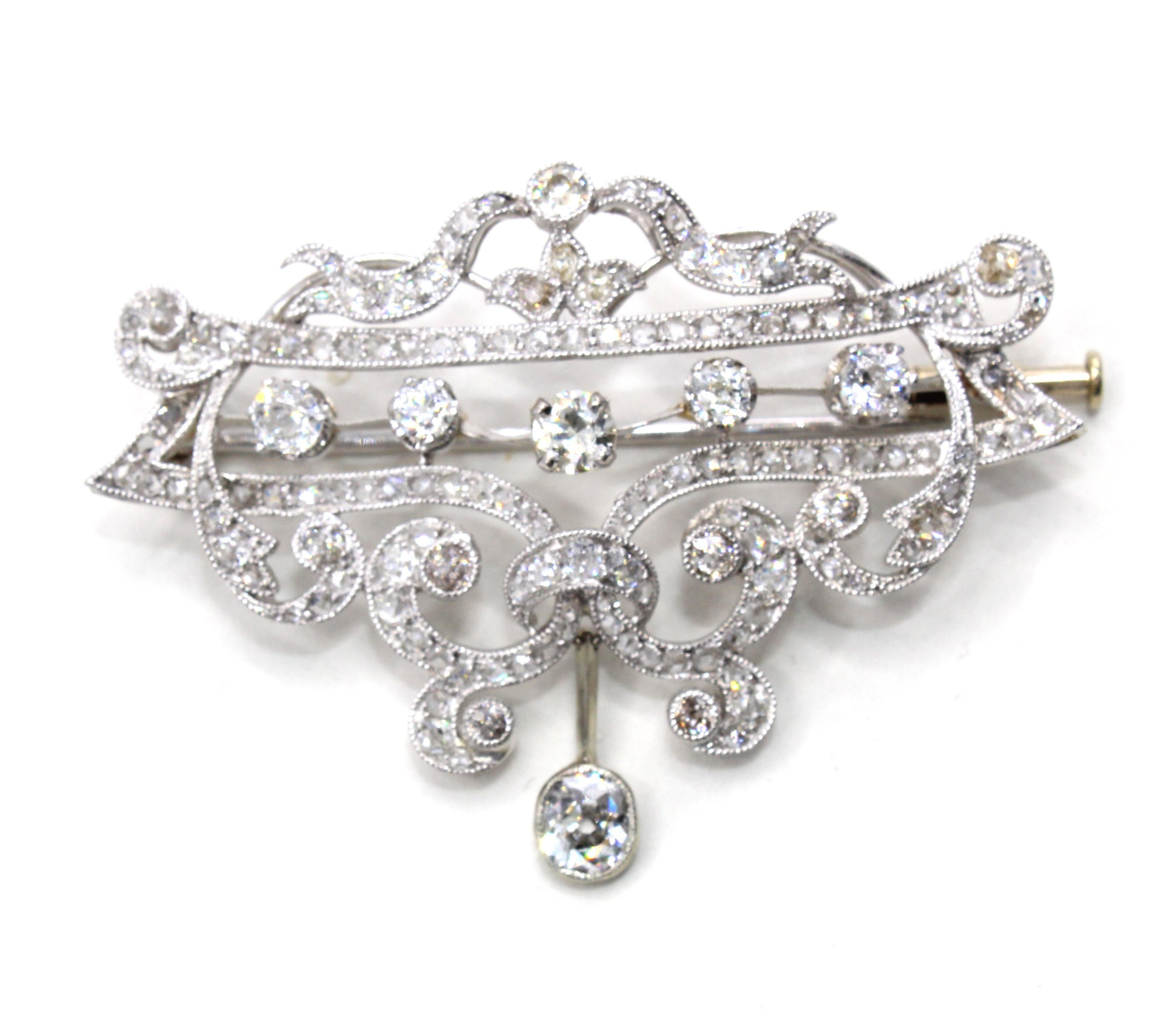 Beautifully designed and masterfully handcrafted, this Edwardian brooch from ca. 1910 exhibits the skilled techniques of a master jeweler. From wonderful ajour work to fine milligrain along the edges of all the channel settings to the curved and