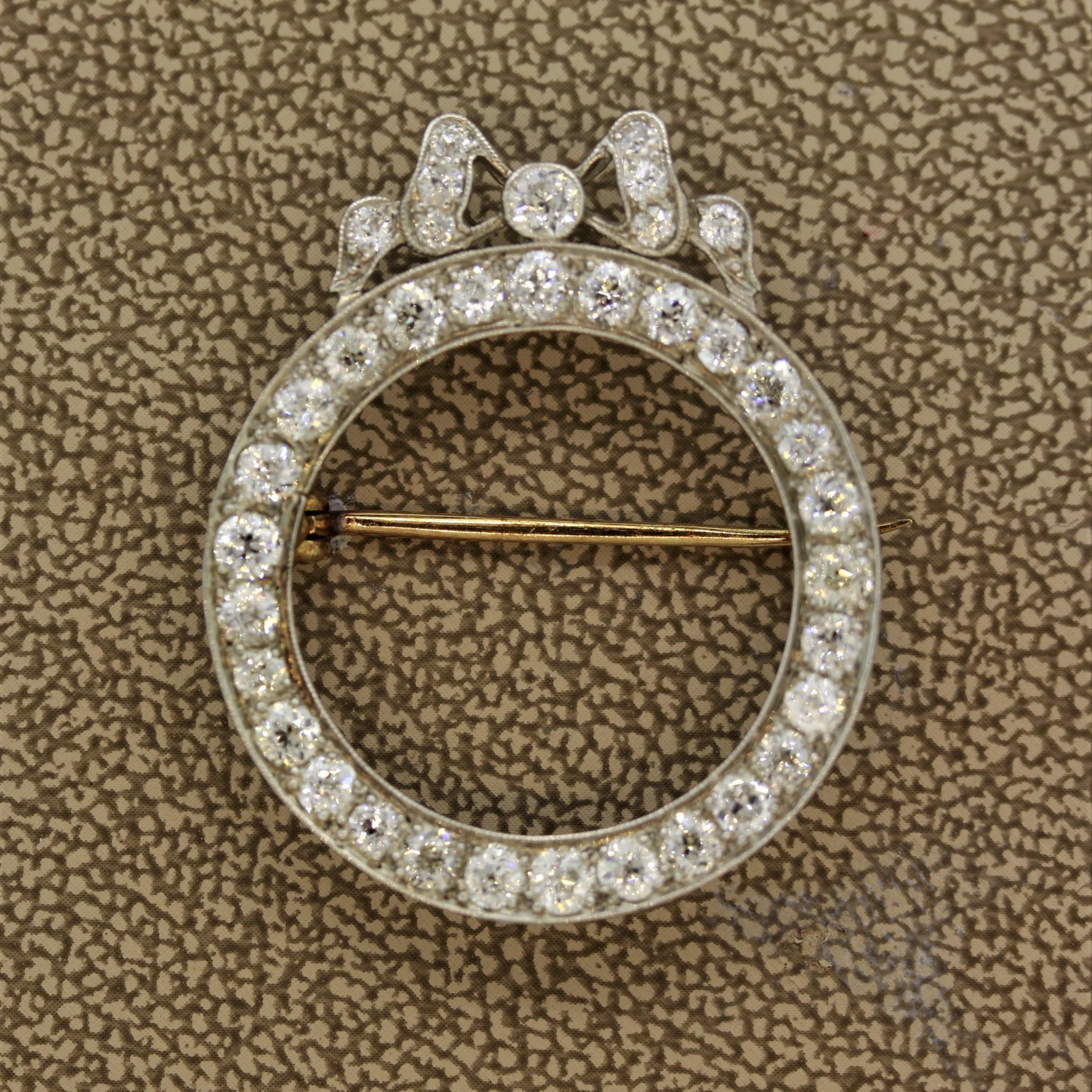 A sweet and finely made classic Edwardian piece of jewelry, circa 1905. It features 3 carats of round European cut diamonds set around in a circle as well as in a fine bow on top of the brooch. The borders of the piece are finished with a soft