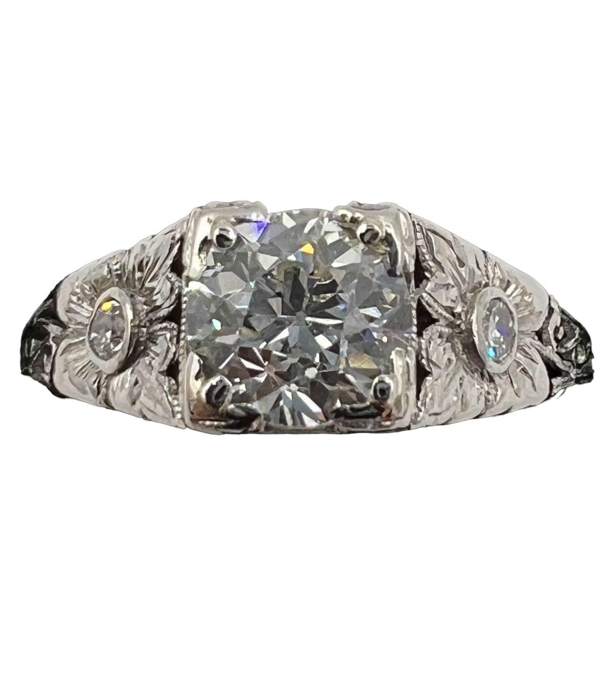 Edwardian diamond platinum engagement ring, circa 1910.

 This Edwardian diamond platinum ring from around 1910, is a one of a kind design.  Featuring a a center set old European cut diamond flanked by two flowers (which resemble stylized Tulips) on