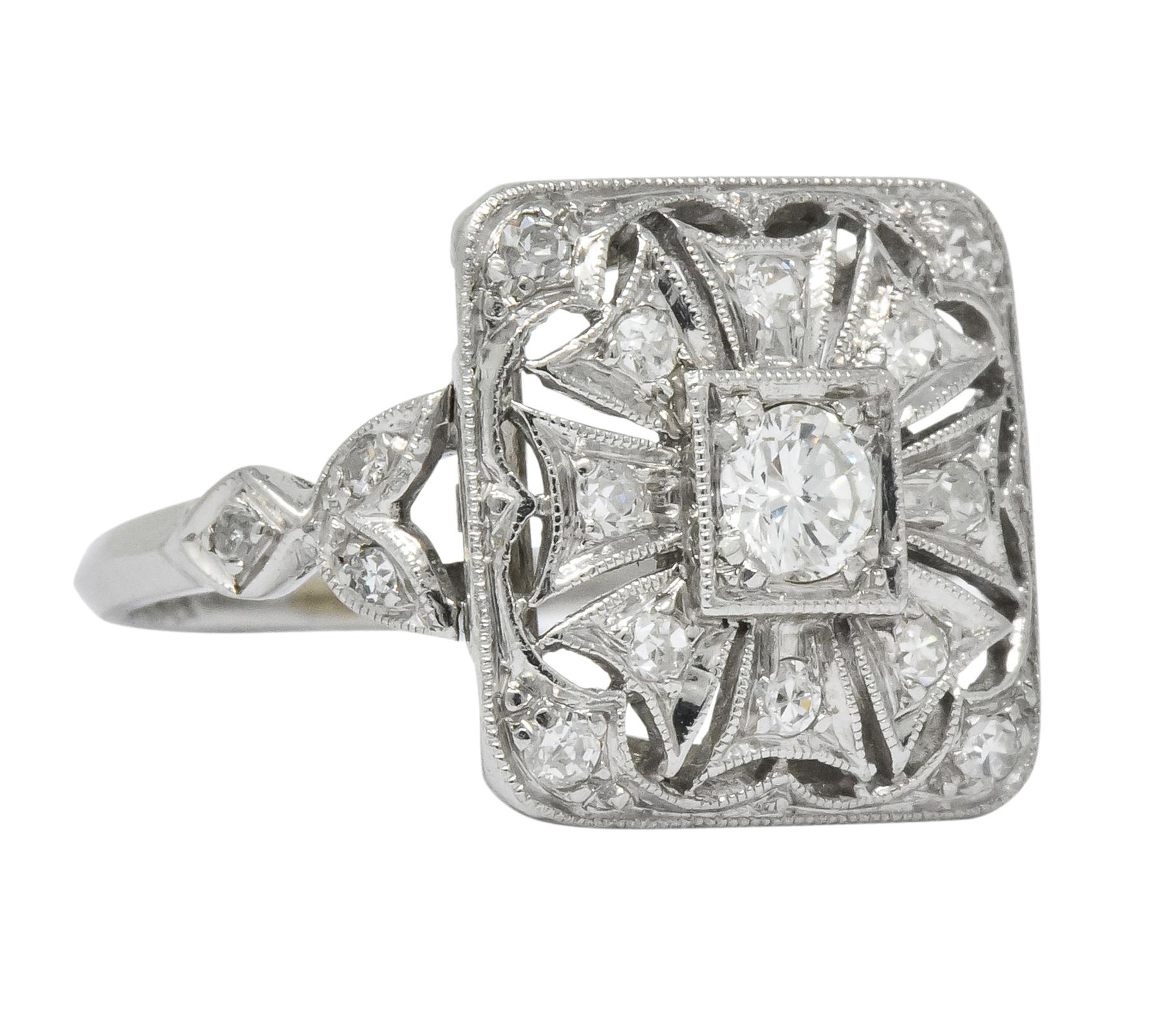 Square shaped mount with millegrain edges and pierced geometric flower motif

Centering a bead set round brilliant cut diamond weighing approximately 0.12 carat, I color and SI1 clarity

Surrounded by bead set single cut diamonds weighing