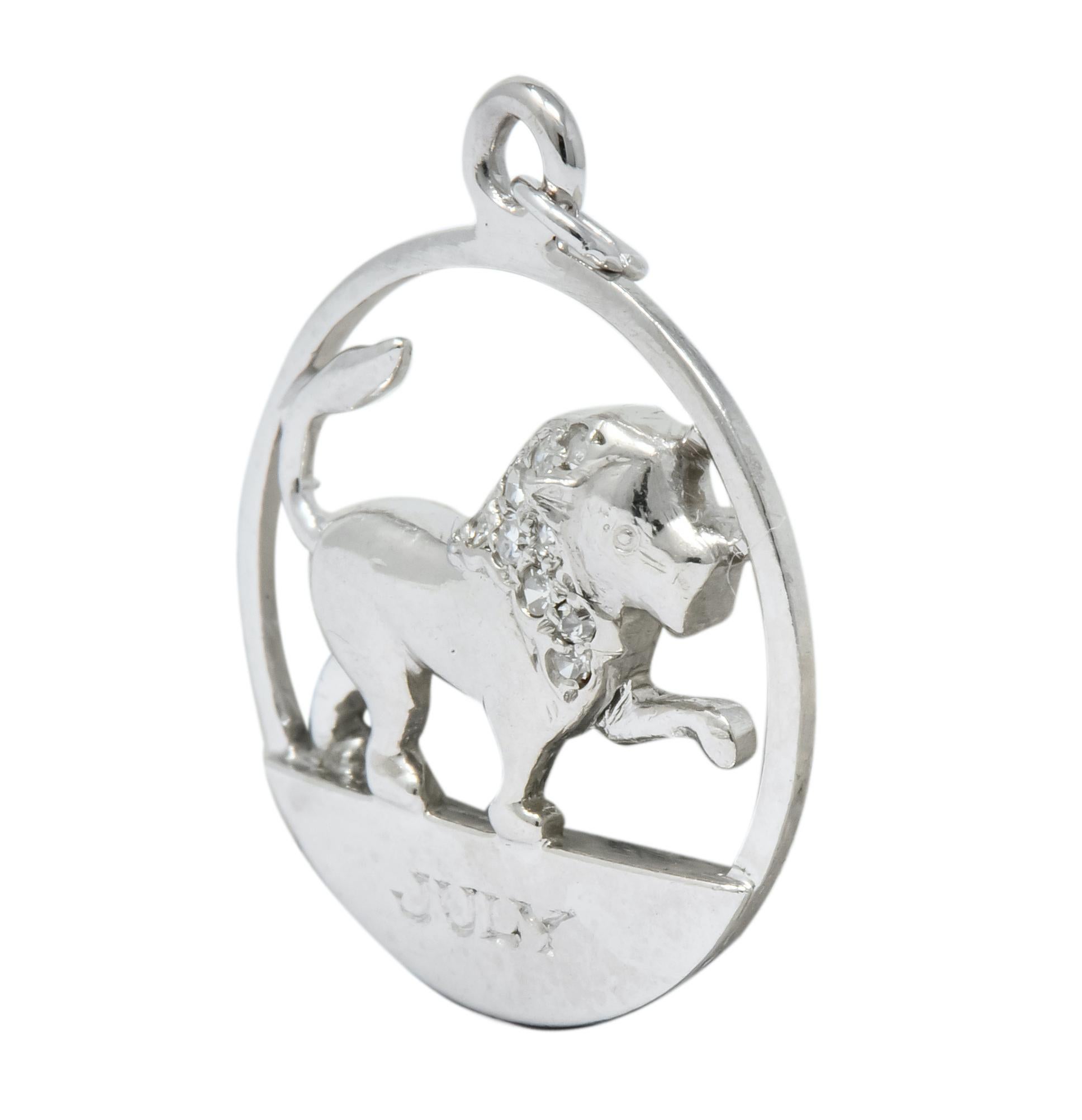 Circular charm designed as a proud lion lifting a paw with July inscribed below

It's mane accented with single cut diamonds, eye-clean and white

Completed by jump ring bale

Tested as platinum

Measures: 5/8 x 13/16 (including bale) inch

Total