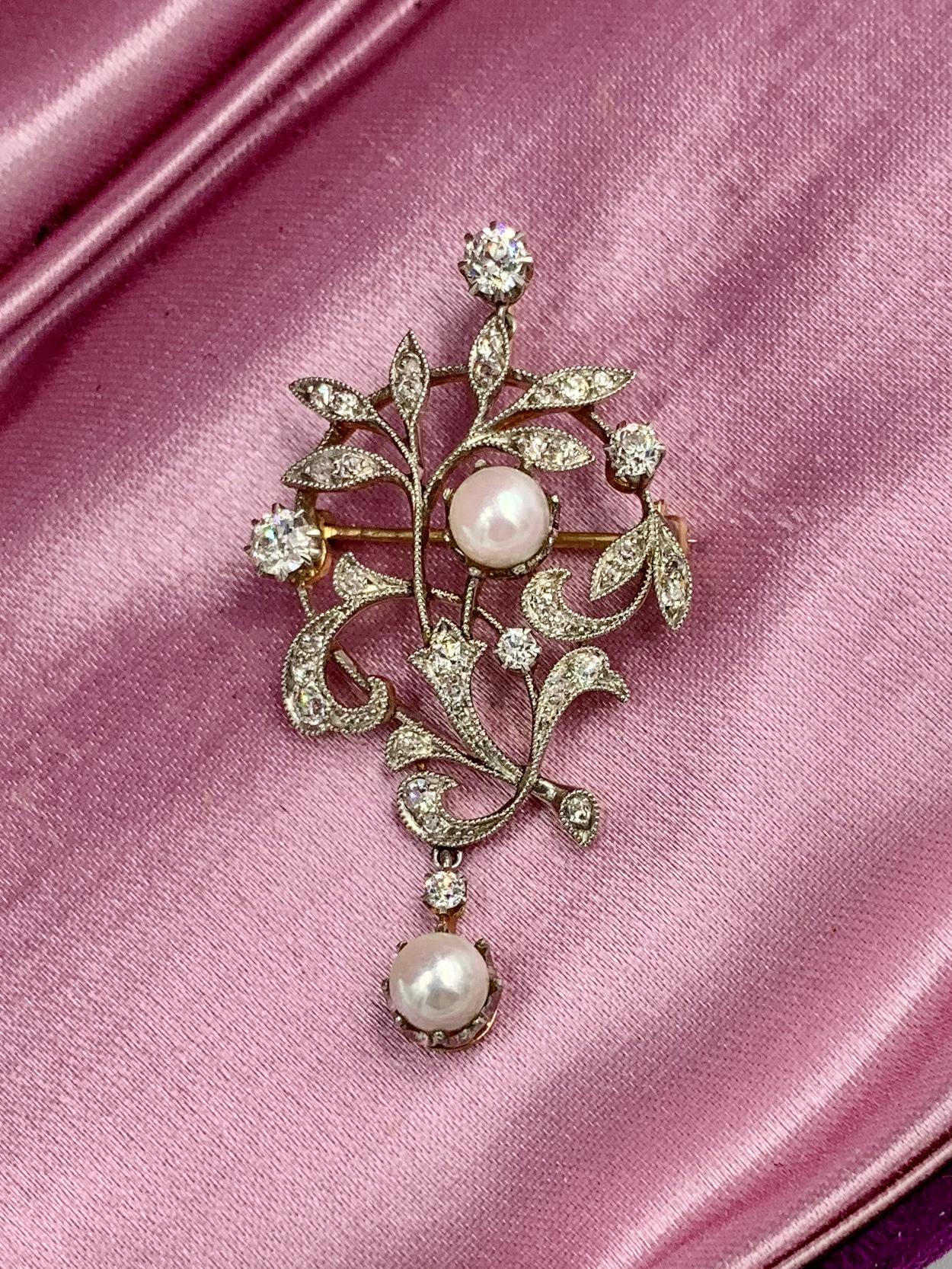An extraordinary Edwardian - Victorian Pendant with spectacular Old Mine Cut Diamonds of incredible white color and fire, and two stunning silvery white Pearls.  The Diamonds and Pearls are set in Platinum atop 14 Karat Gold as was the custom of the