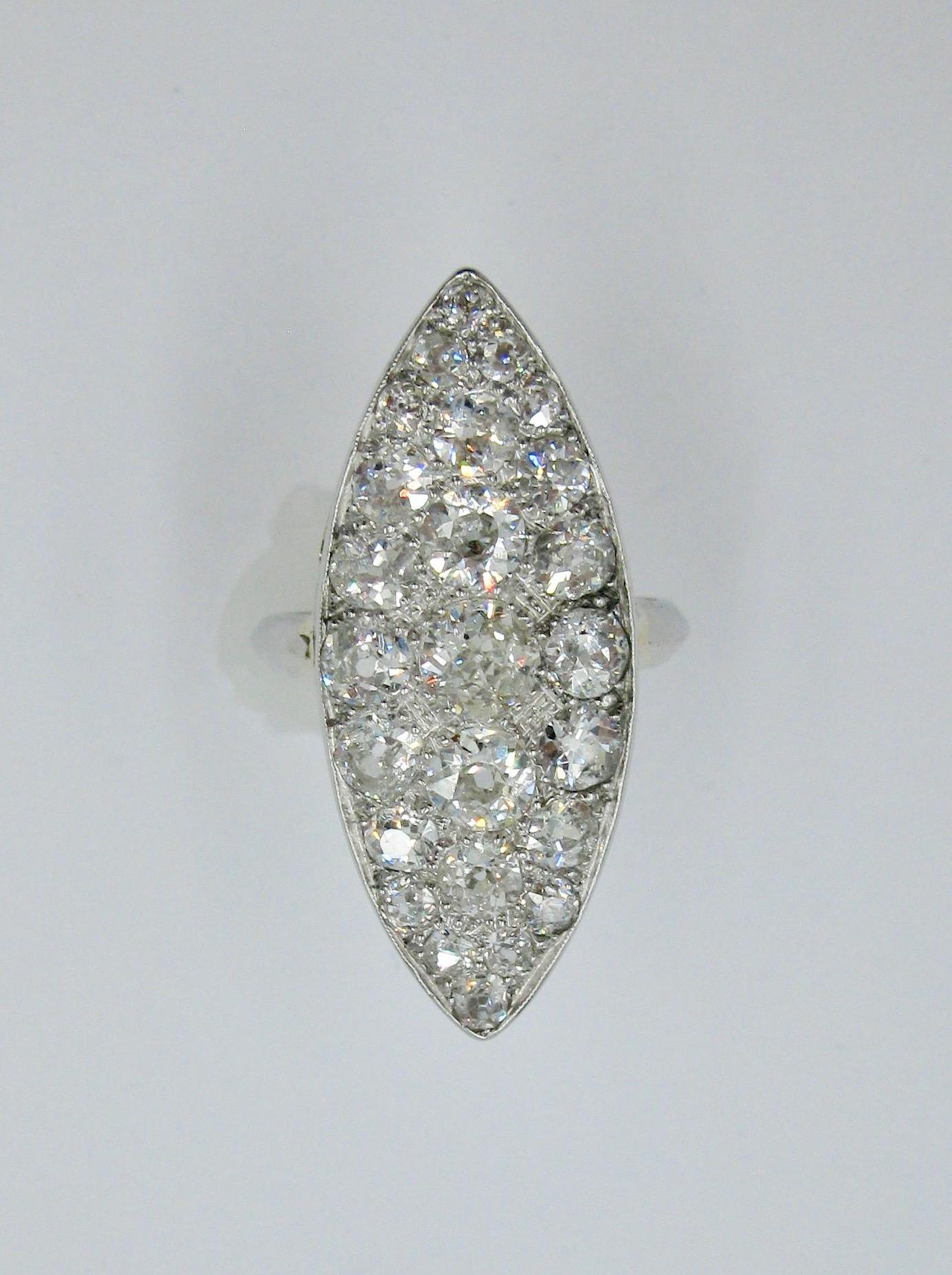 A dramatic Antique Edwardian Diamond Ring in Platinum with 3.5 Carats of spectacular G color (white white white) and VS clarity (clean) Old European Cut Diamonds.  This monumental antique Edwardian to Victorian diamond ring has a central diamond of