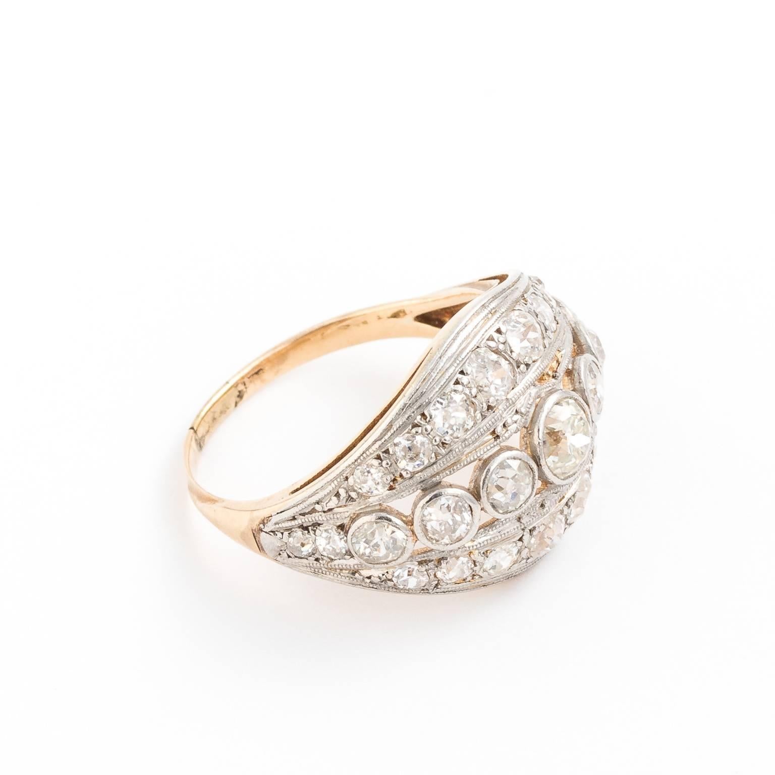 Circa 1910 multi-diamond stone ring consisting of diamonds weighing a total of 1.50cts. Set into platinum with three rows defined by a linear motif in platinum with 14kt yellow gold.
