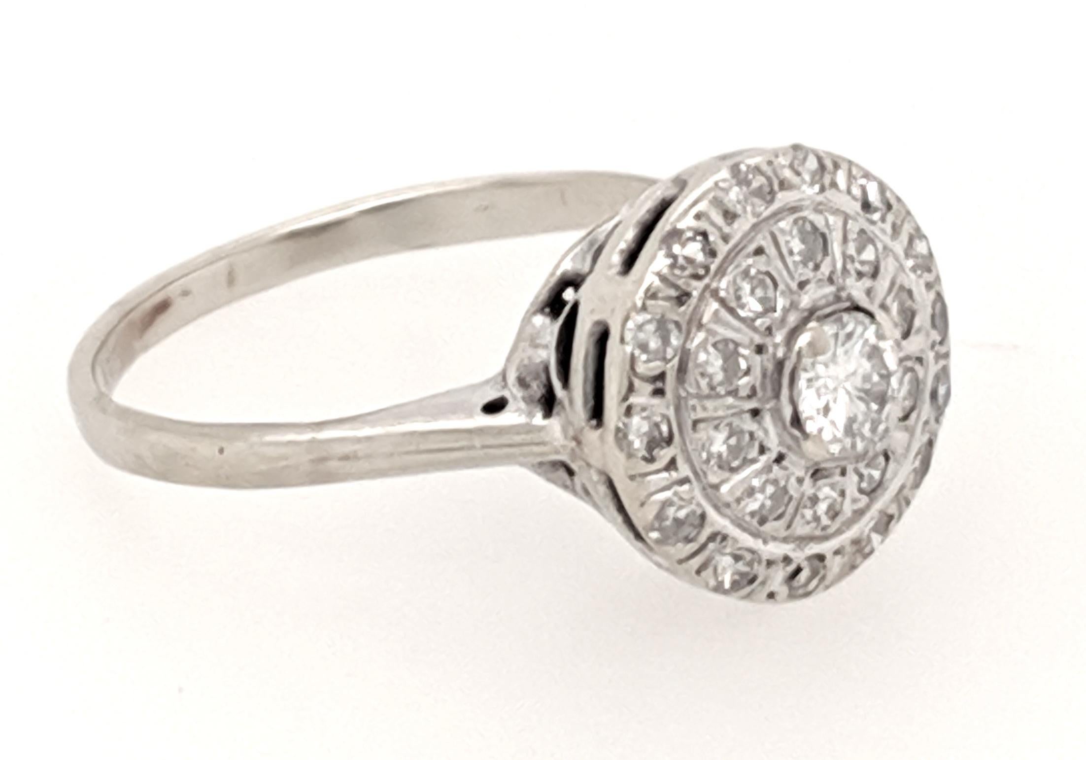 An Edwardian diamond ring crafted in 14k white gold featuring (1) round diamond weighing .20ct with very good color 