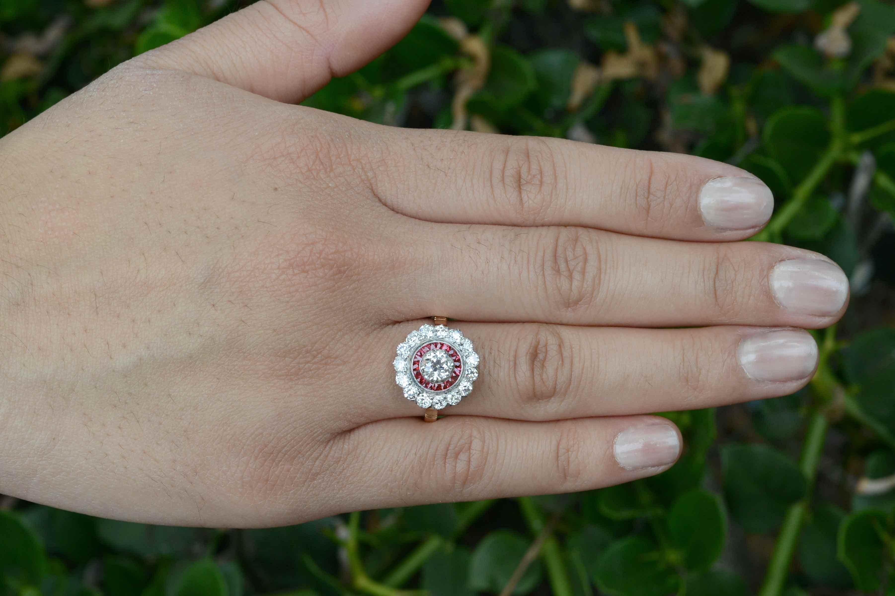 Reserved for a customer, do not purchase.

Centering on a bright and fiery old European cut 1/2 carat diamond, the alluring ruby flower cluster is so feminine. The sought after halo design is accented with French cut calibre' natural rubies  of a