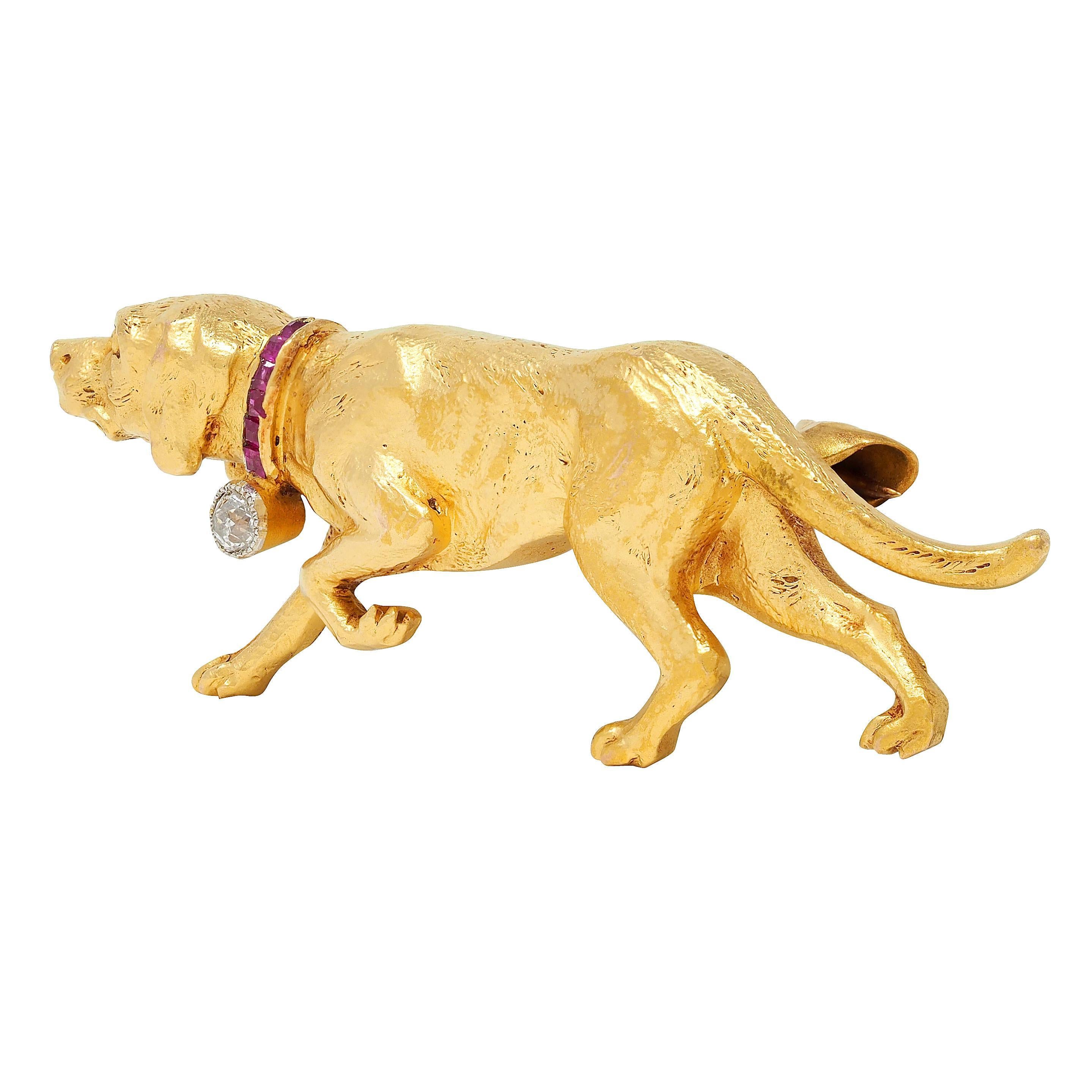 Designed as a highly rendered yellow gold hound dog with engraved fur and grooved features
Depicted walking with pointed nose and wearing a channel set step cut ruby collar
Weighing approximately 0.06 carat total - transparent medium red in