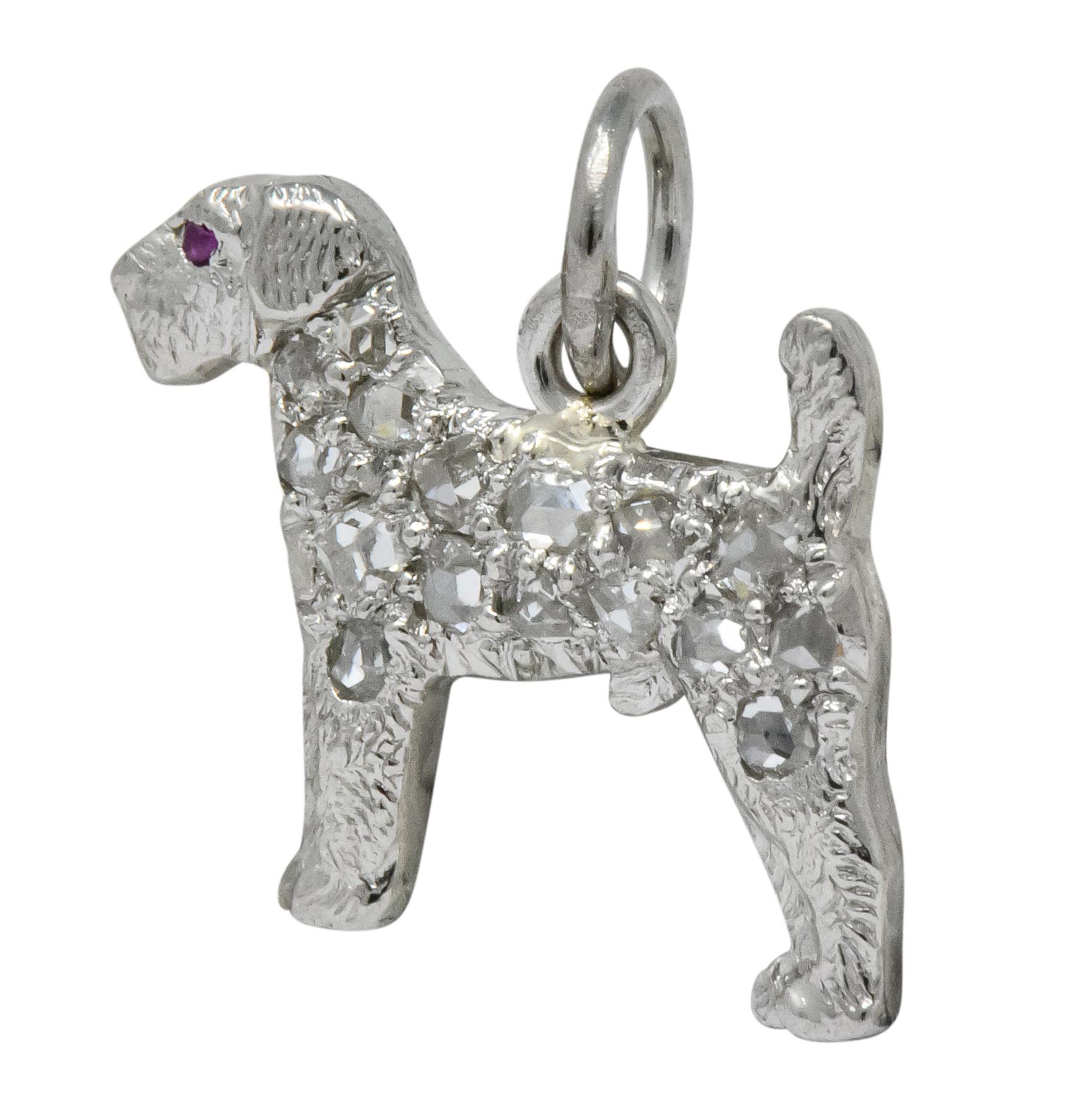 Dog charm with detailed fur texture and pavé set throughout with rose cut diamonds and small round cut ruby eye

Completed by jump ring

Signed J.E.C & Co for J.E. Caldwell

Tested as platinum

Circa 1920

Measures: approx. 1/2 x 1/2 (including