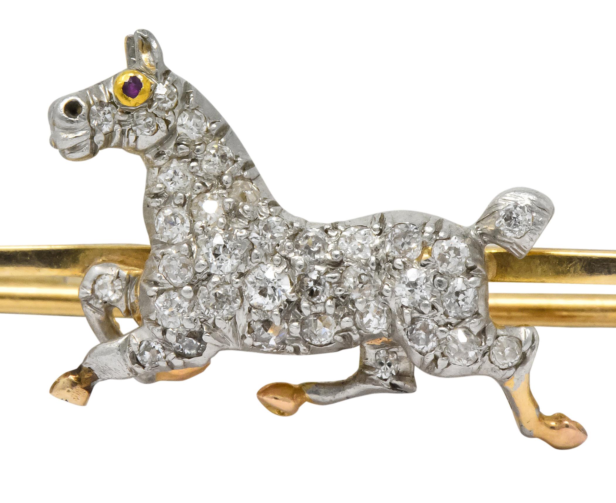 Designed as a galloping horse with diamonds set throughout and a round cut ruby eye

Set with old European and Swiss cut diamonds, total diamond weight approximately 0.55 carat. GHI color and VS to SI clarity

On a safety pin style finding

Pin