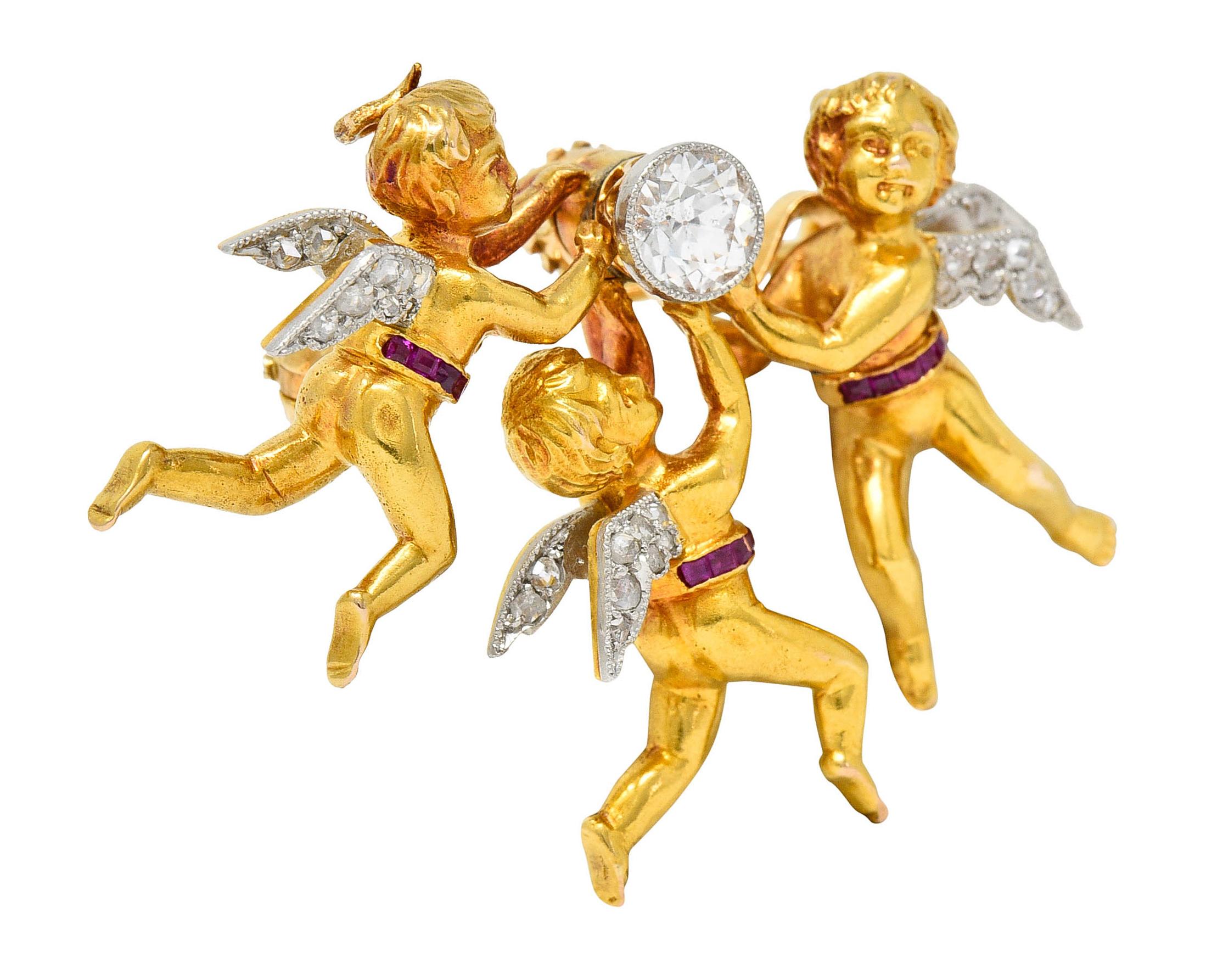 Pendant brooch is designed as a triad of winged cherubs uplifting an old European cut diamond

Bezel set in platinum while weighing approximately 0.52 carat with I/J color and SI clarity

Wings are accented by rose cut diamonds weighing