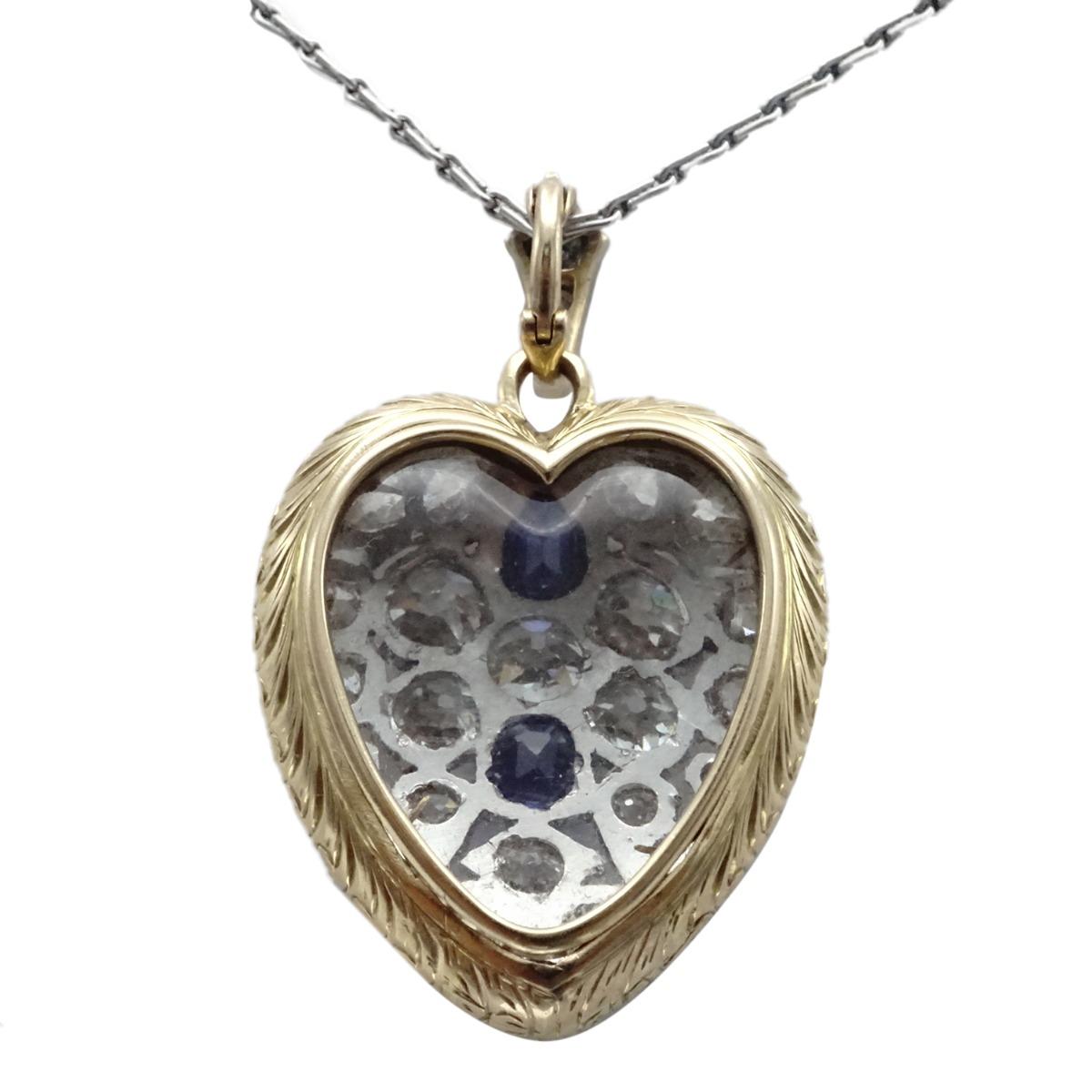 Crafted in platinum and 18 karat yellow gold this locket features old european cuts and 2 cushion cut beautiful sapphires.  Locket dimensions length 1 1/2