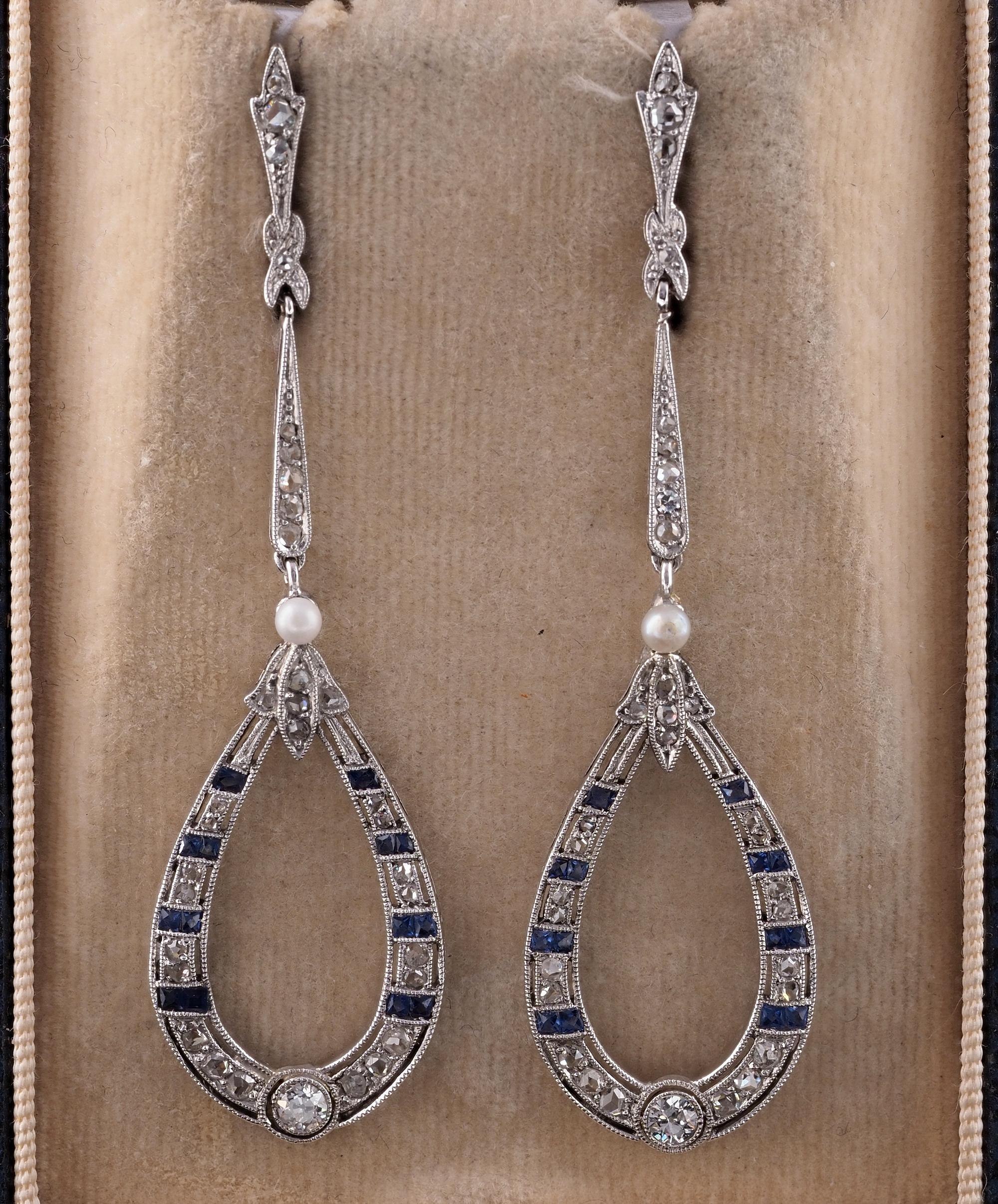 Without Time
Stunning articulated long drop earrings from the Edwardian period, 1905 ca
Hand fabricated in Platinum, elegantly elongated, airy and sleek shape, finely worked with detailed millgrain enhancing the delicacy of Diamond and Sapphire
Set