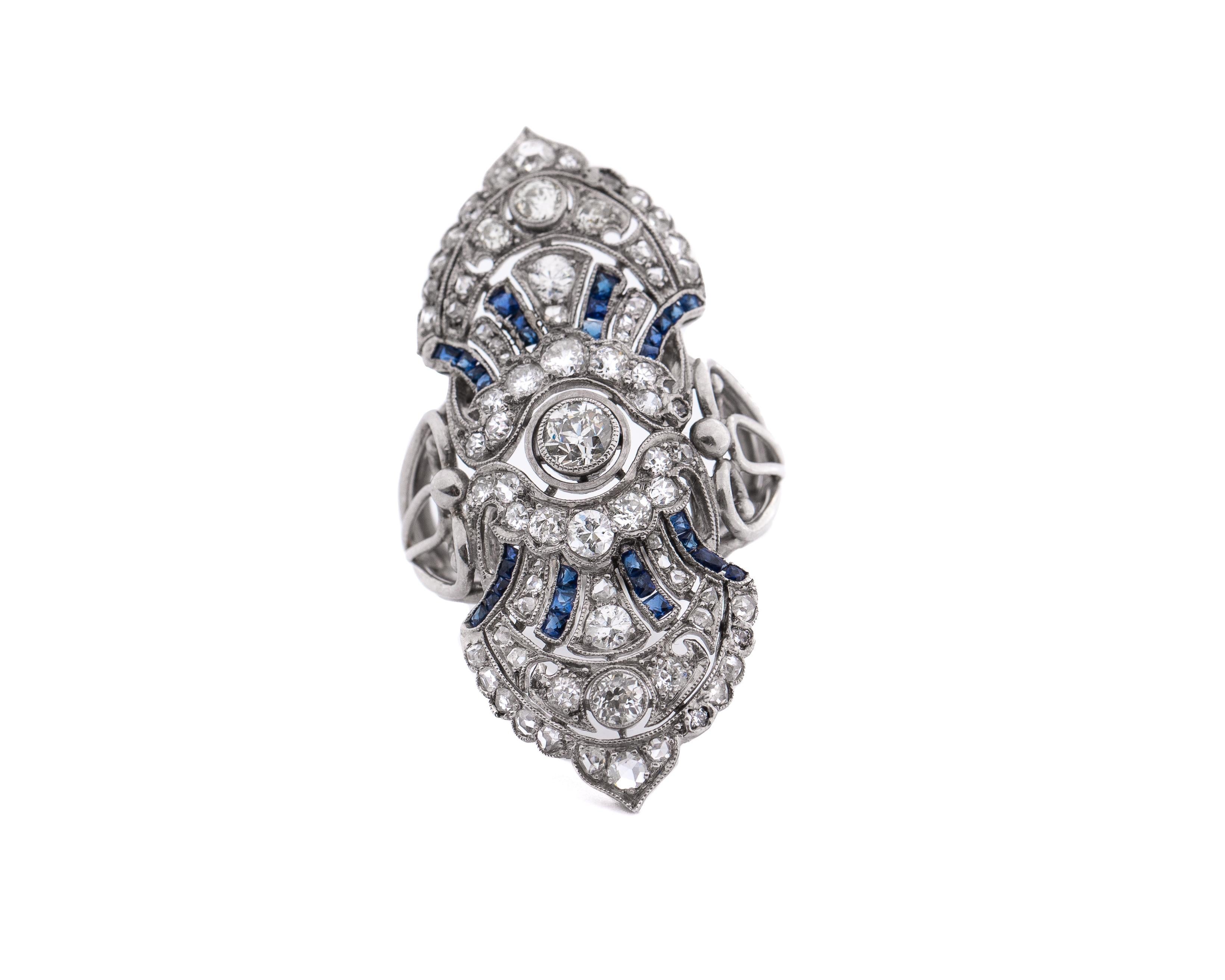 Here we have an extremely well done example of an early 1900s brooch converted long ago into a fantastic statement ring! This stunning shield is crafted in platinum with a total of 1.73 carats of dazzling old cut diamonds adorning the stylish