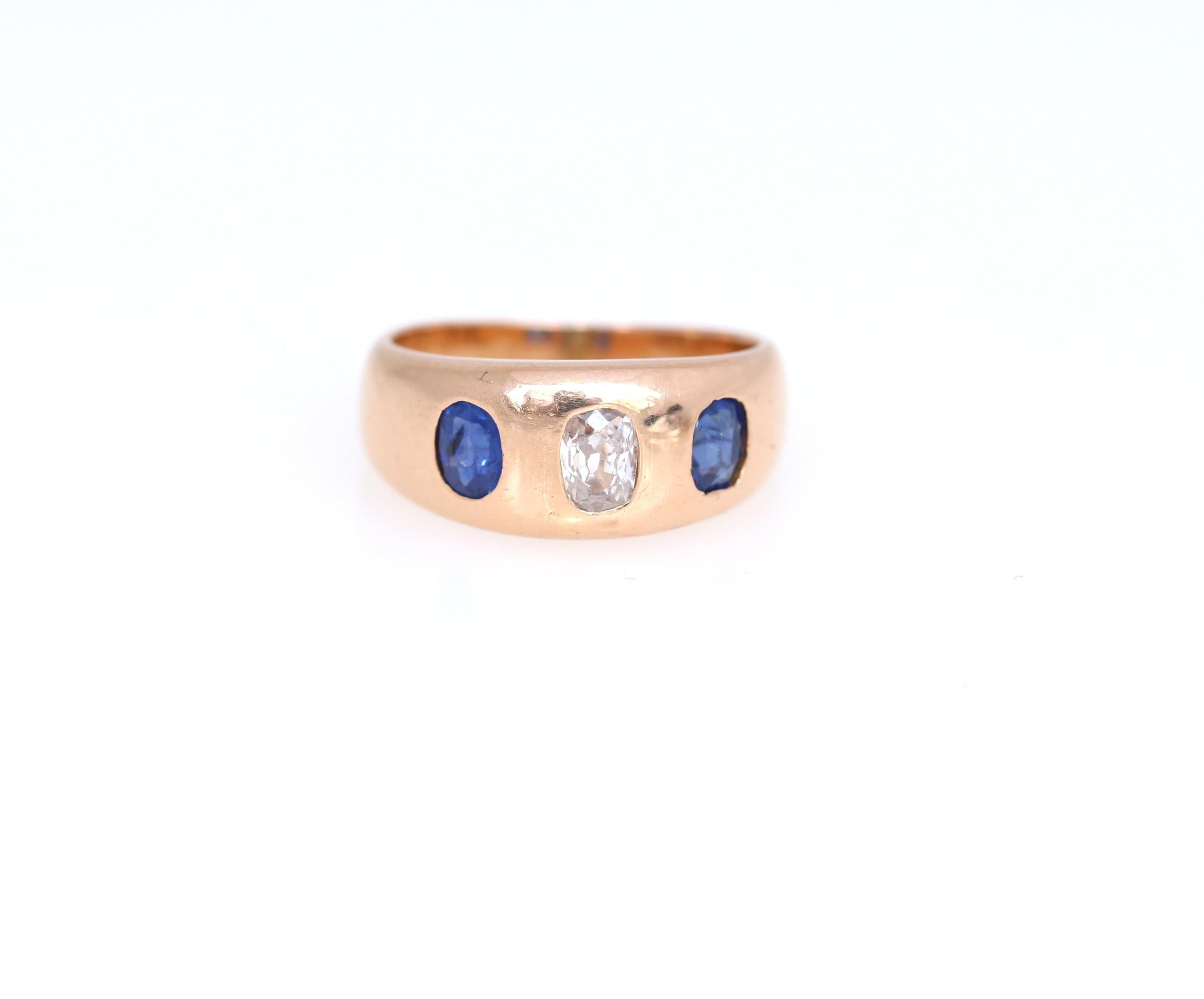 Stylish and classic design with a Diamond in the middle and two dark blue Sapphires by sides. 1910  Perfectly matched both for Ladies and Gents. 18K Gold. 

Diamond approximate weight: 0.25Ct Each Sapphire approximate weight: 0.20Ct

Dimensions: