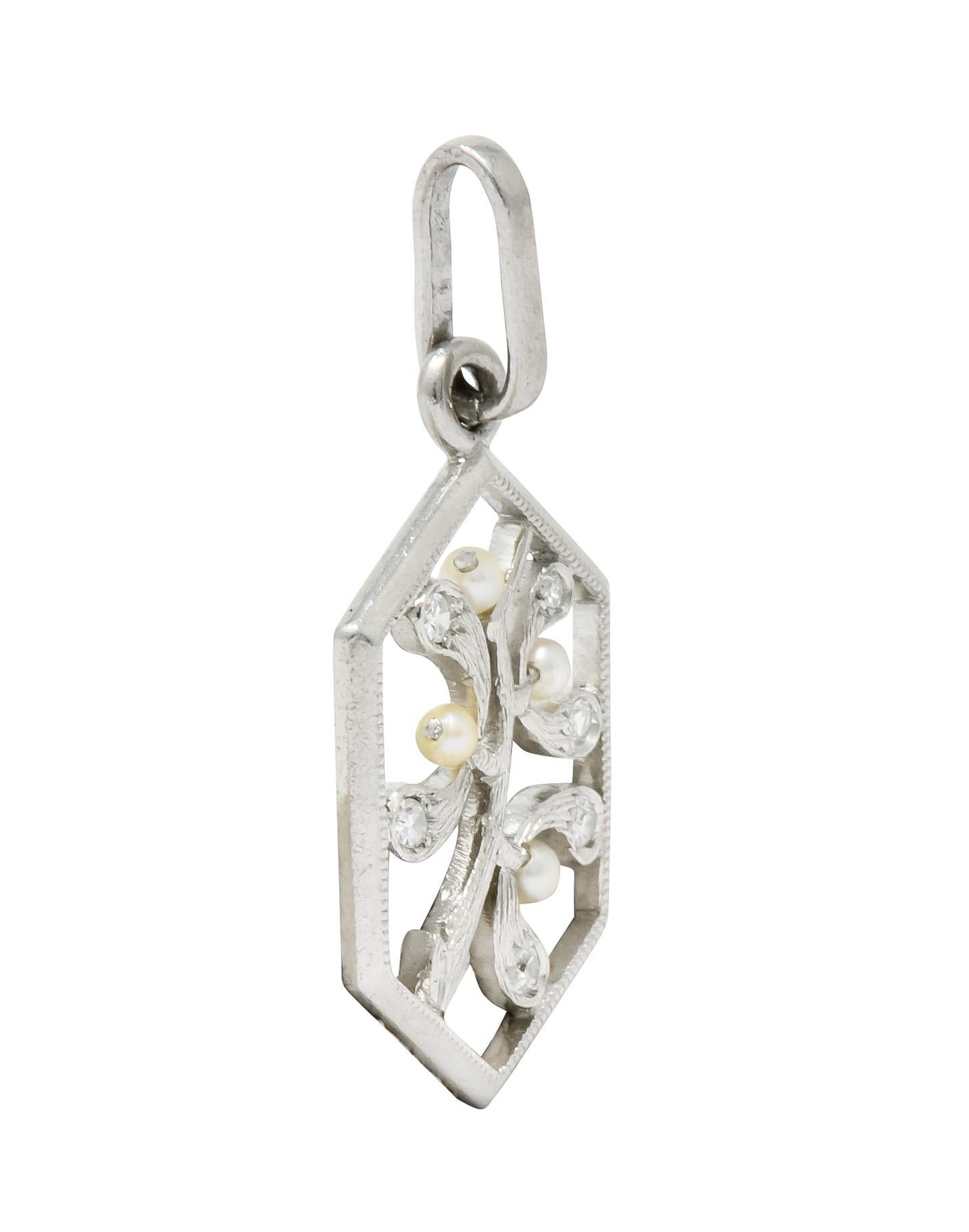 Centering a stylized rendering of a maple branch ripe with three winged samara seed pods

With 1.5 mm round freshwater seed pearls, cream in body color with excellent luster

Accented by six single cut diamonds weighing approximately 0.12 carat