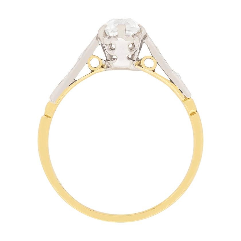 This elegant and classic solitaire features an old cut diamond set to centre. The stone, which weighs 0.65 carat, has been claw set and graded as H in colour and VS1 in clarity. Th collet has been made in platinum, as are the shoulders which have