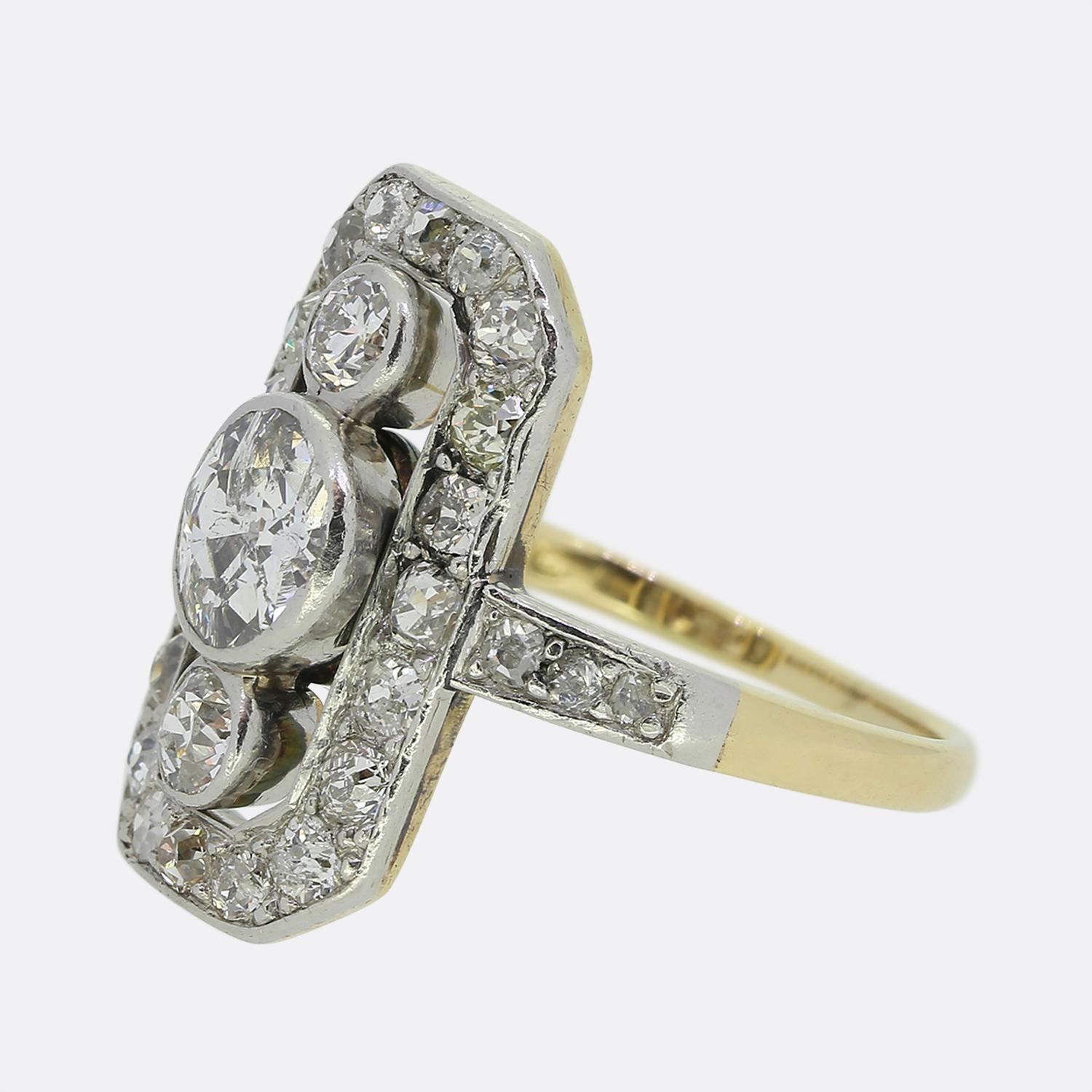 Here we have a lovely diamond tablet ring dating back to the Edwardian period. A single sizeable old cut diamond sits risen at the centre of an open face and is top and tailed by a slightly smaller matching stone above and below. These principal