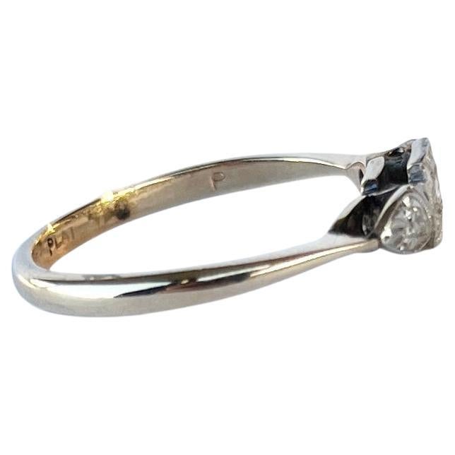 Three diamonds sit fabulously on top of a simple setting modelled in 9ct gold and stones set in platinum. The central round diamond measures 4pts and the rose cut diamonds either side measure 2pt each.  

Ring Size: O 1/2 or 7 1/2 
Height Off
