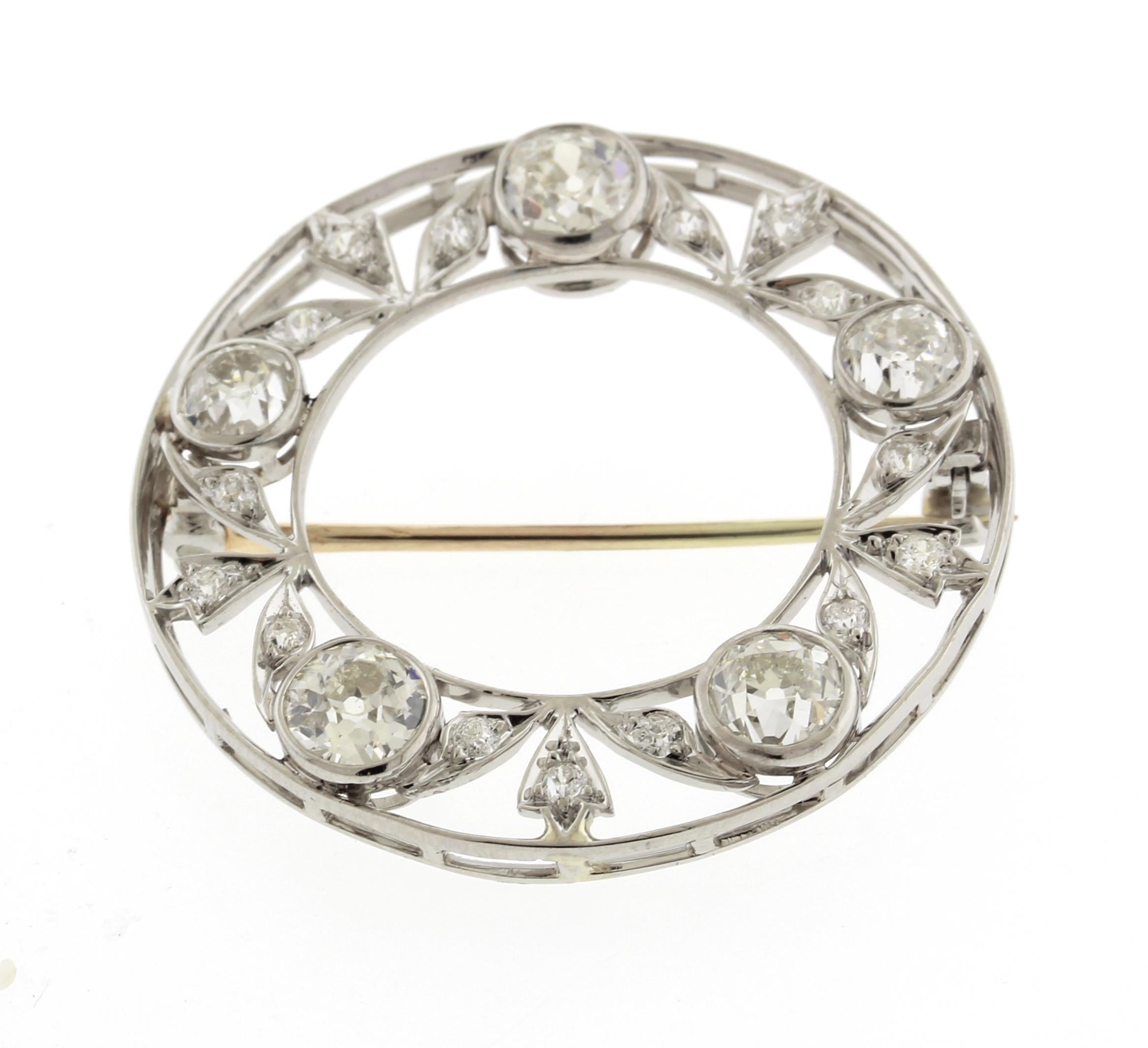 This Edwardian brooch is easy to wear with any outfit.  
• Metal: Platinum
• Circa: 1910s
• Gemstone: Diamonds
• Diamonds: 5 OEC/OMC =approximately 2 cts
                     15 smaller diamonds= .15cts
• Diameter: 1 1/4inches
• Weight: 7.6 grams
•