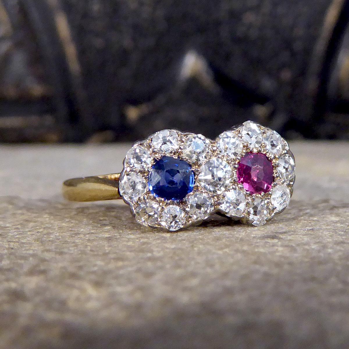 An absolutely stunning Edwardian piece. This ring features two Daisy clusters one with a bright blue Sapphire and the other a vibrant Ruby in the centre with a total of 15 Old Cut Diamond surround forming a double Daisy Cluster style with an 18ct