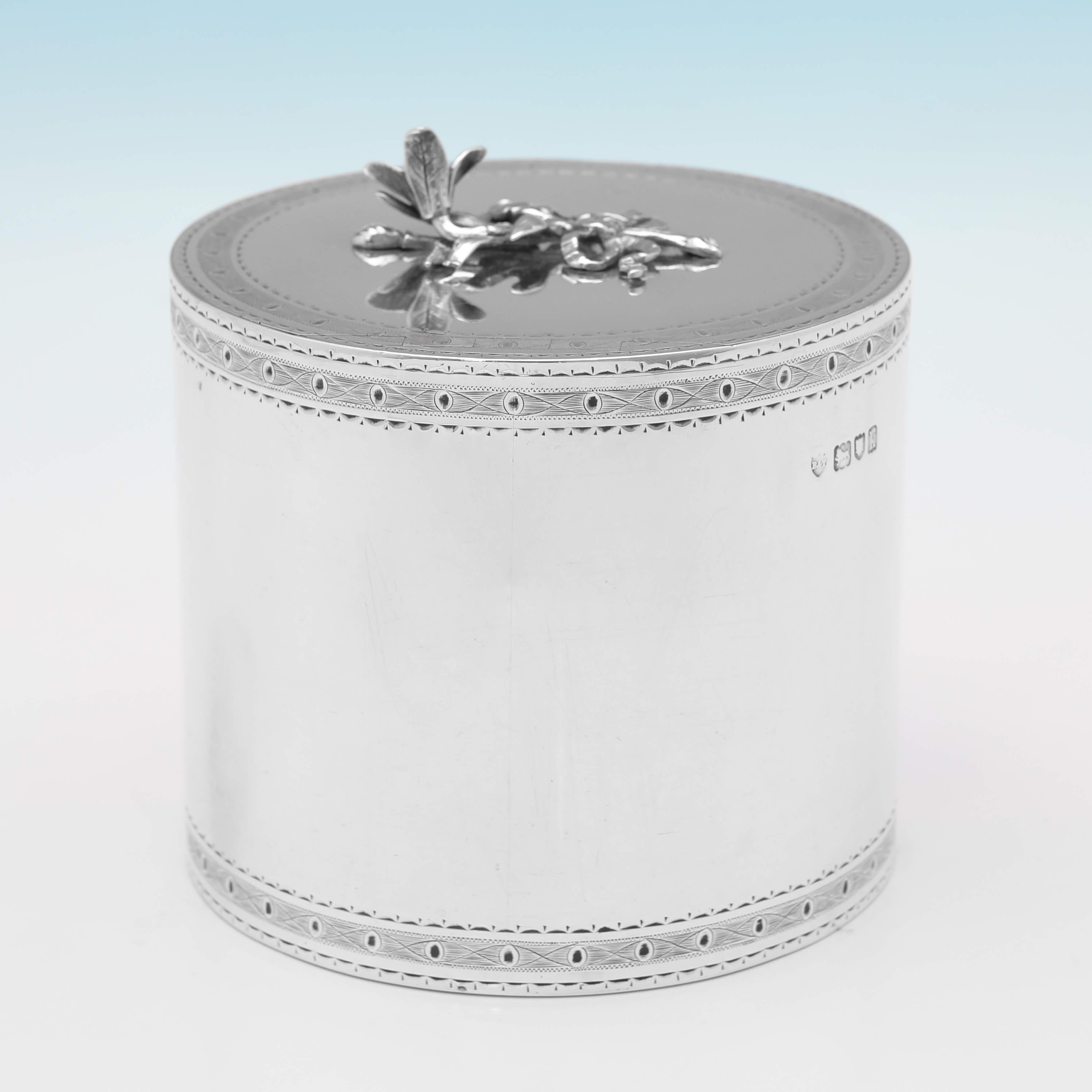 Hallmarked in London in 1905 by Blackburn & Tysall, this very attractive, Edwardian, Antique Sterling Silver Tea Caddy, features bright cut engraved decorative bands and cartouche, and a tea flower finial. 

The tea caddy measures 5