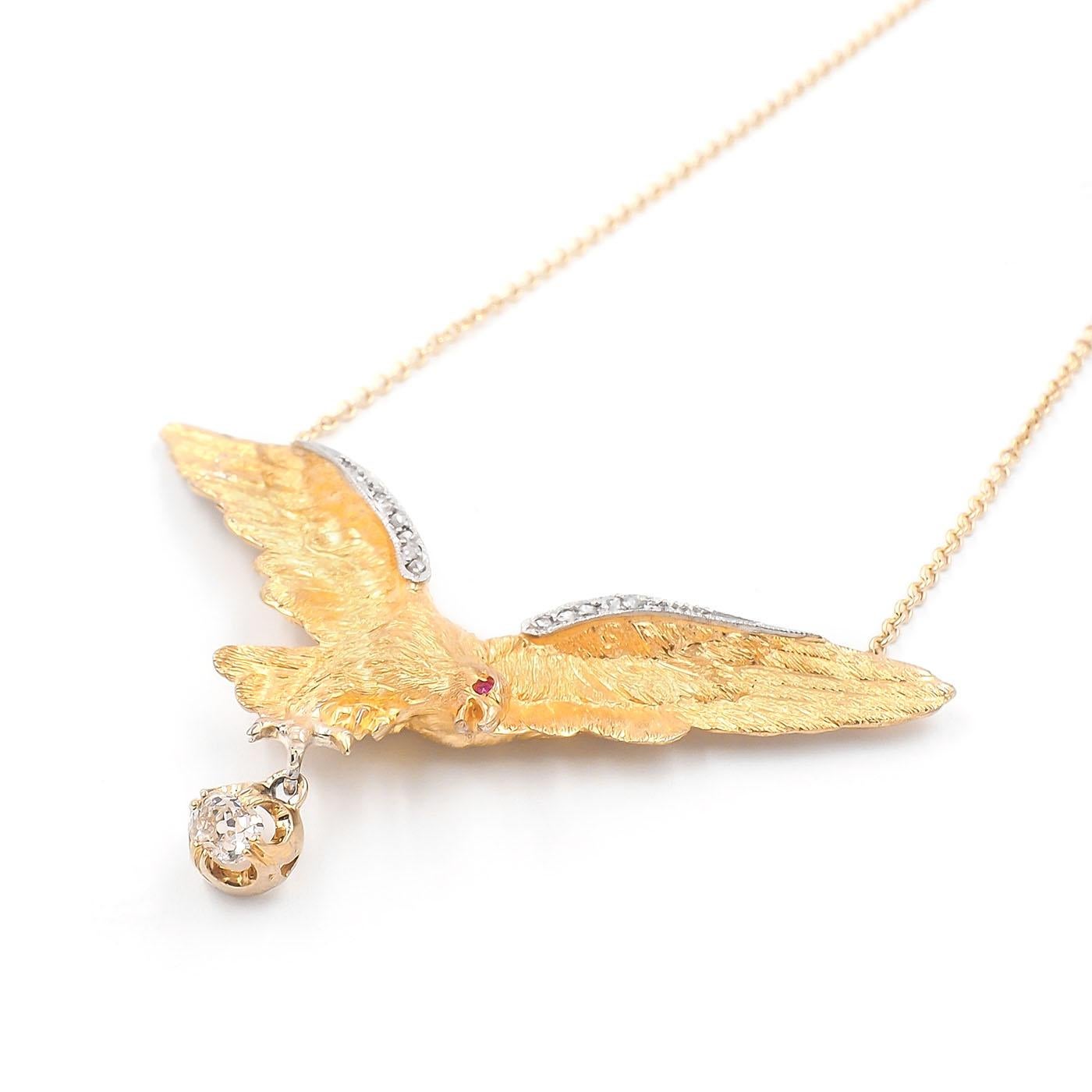 Edwardian era Eagle Pendant Necklace with Old Mine Cut Diamond Drop composed of 18k yellow gold & platinum. Featuring a three dimensional 18k yellow gold eagle with its textured wings spread, dangling an Old Mine Cut diamond from its talons. With a