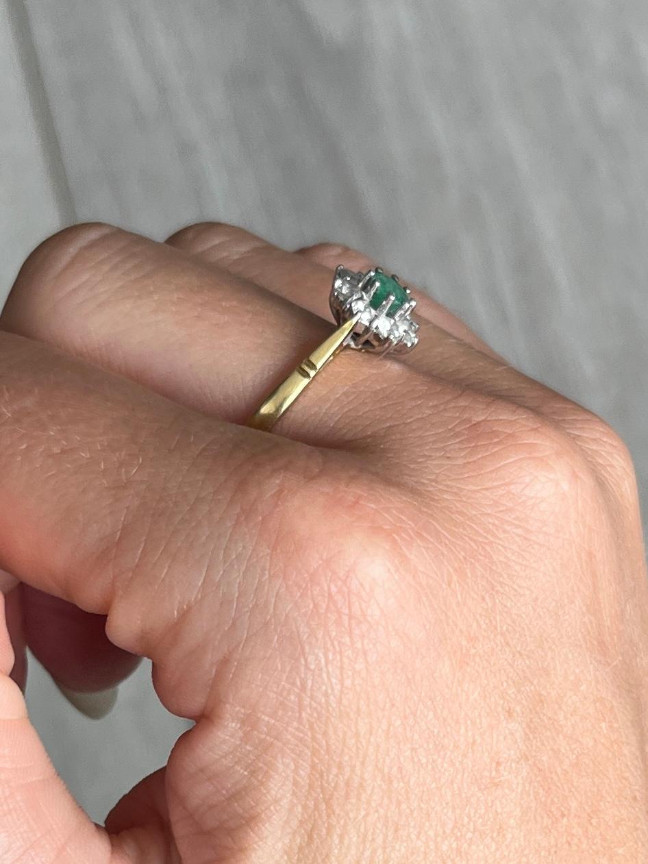 This stunning cluster boasts a 30pt emerald at the centre of it. Surrounding the beautiful green stone are diamonds totalling 40pts. All modelled in 18carat gold and stones set in platinum. Hallmarked London 1984.

Ring Size: O or 7 1/4 
Cluster