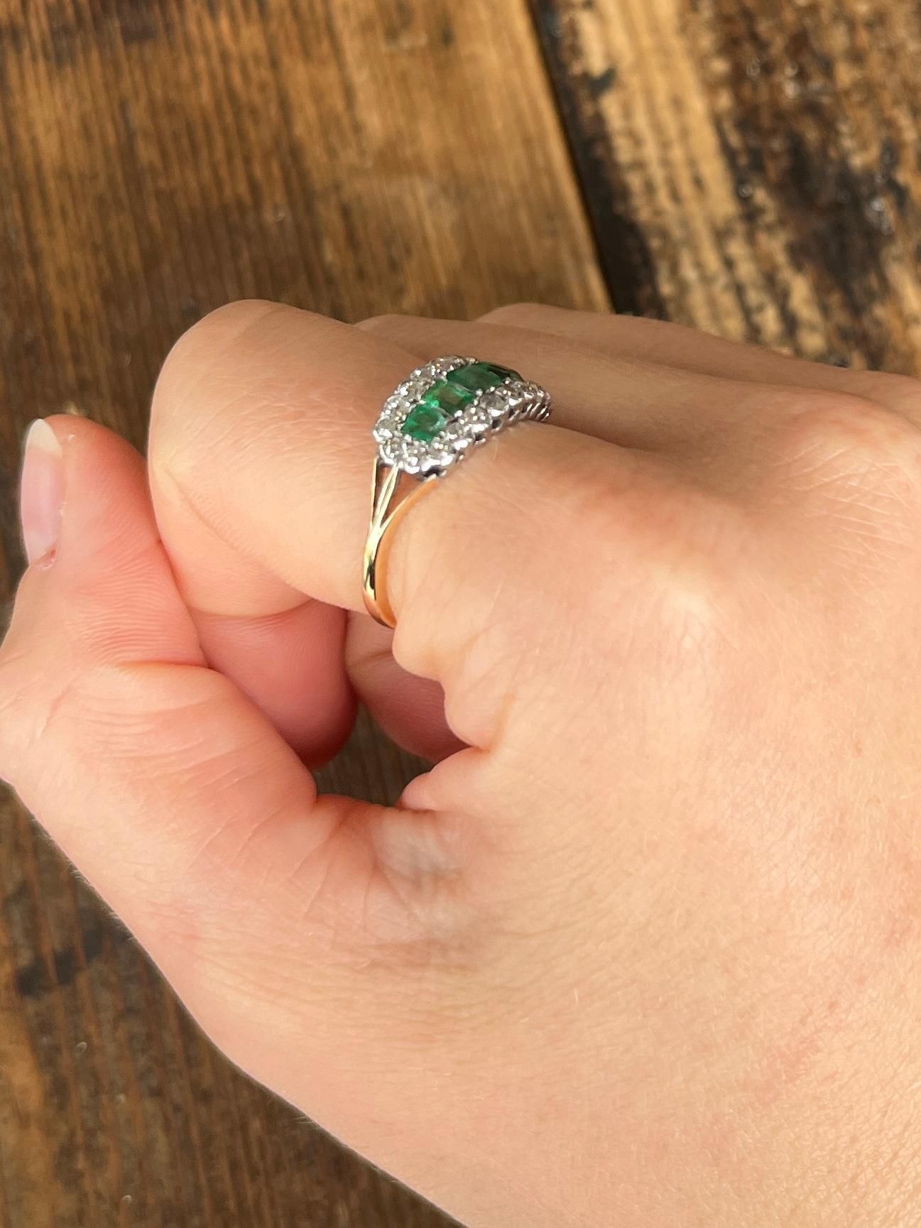 An exquisite five-stone ring set with beautiful square cut emeralds which total 1.1ct. Surrounding the bright emeralds there is a halo of diamonds. The diamonds total 66pts and the stones are all set in platinum and the band is modelled in 18carat