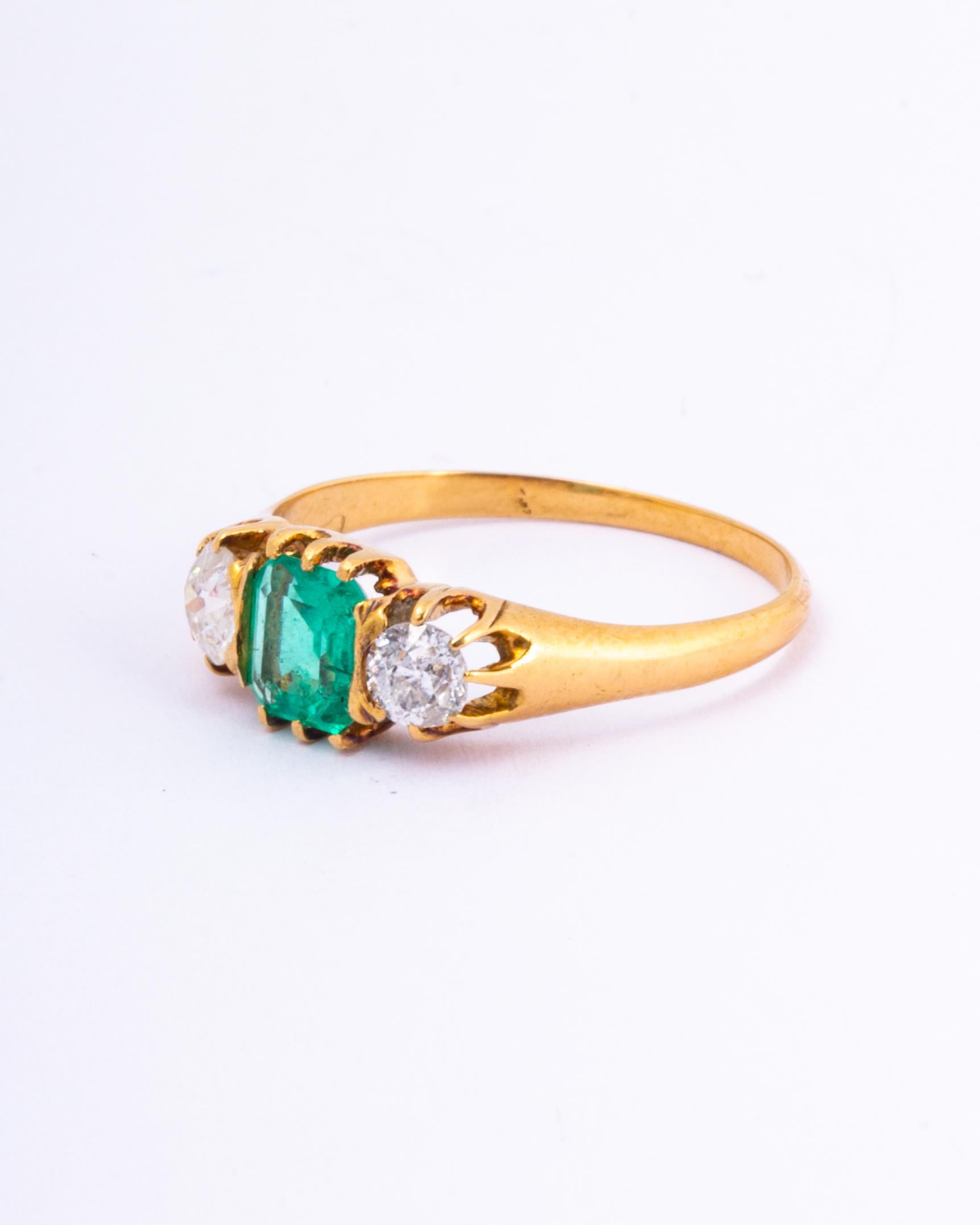 The central emerald is so bright and beautiful and measures 75pts. Sat either side it are two bright shimmering old European cut diamonds each measuring 30pts. The ring is modelled in 18ct gold.

Ring Size: O 1/2 or 7 1/2 
Width: 7mm
Height Off