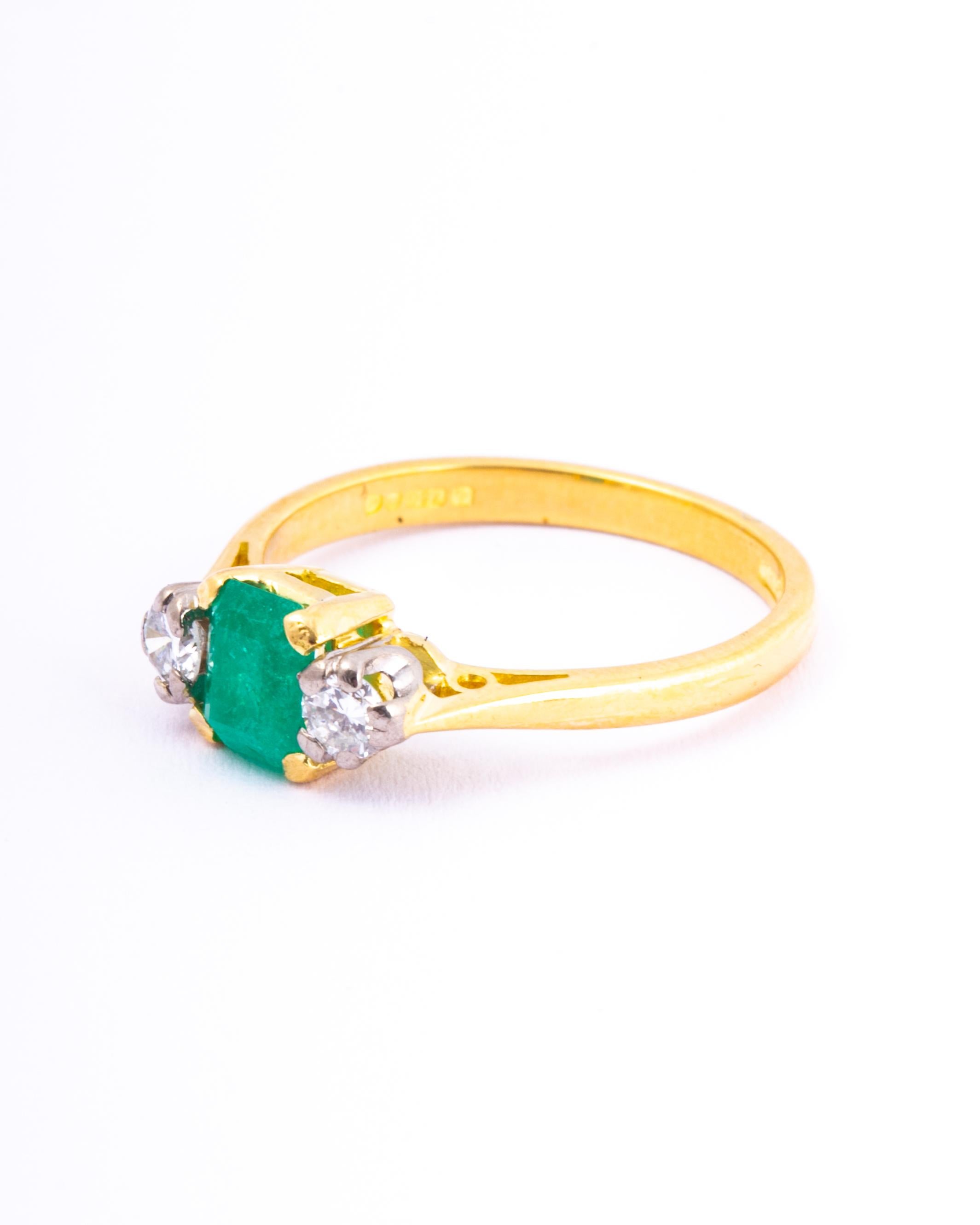 The central emerald is so bright and beautiful and measures 50pts. Sat either side it are two bright shimmering old European cut diamonds each measuring 20pts. The ring is modelled in 18ct gold.

Ring Size: L or 5 3/4 
Width: 5.5mm
Height Off