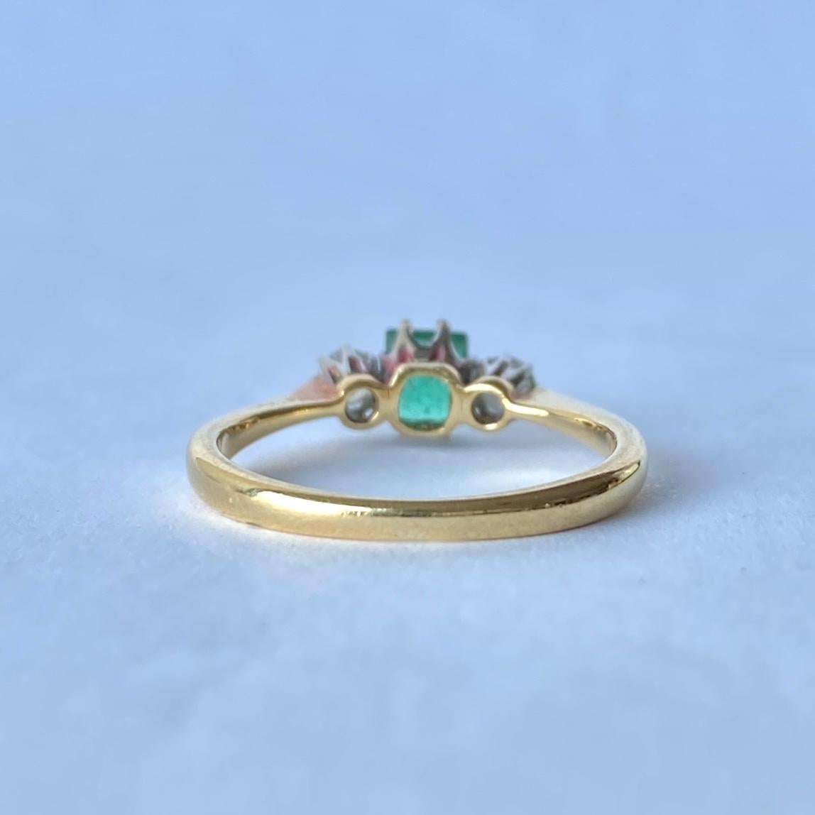 The central emerald is so bright and beautiful and measures 40pts. Sat either side it are two bright shimmering old European cut diamonds each measuring 7pts. The ring is modelled in 18ct gold.

Ring Size: J 1/2 or 5 
Width: 5mm
Height Off Finger:
