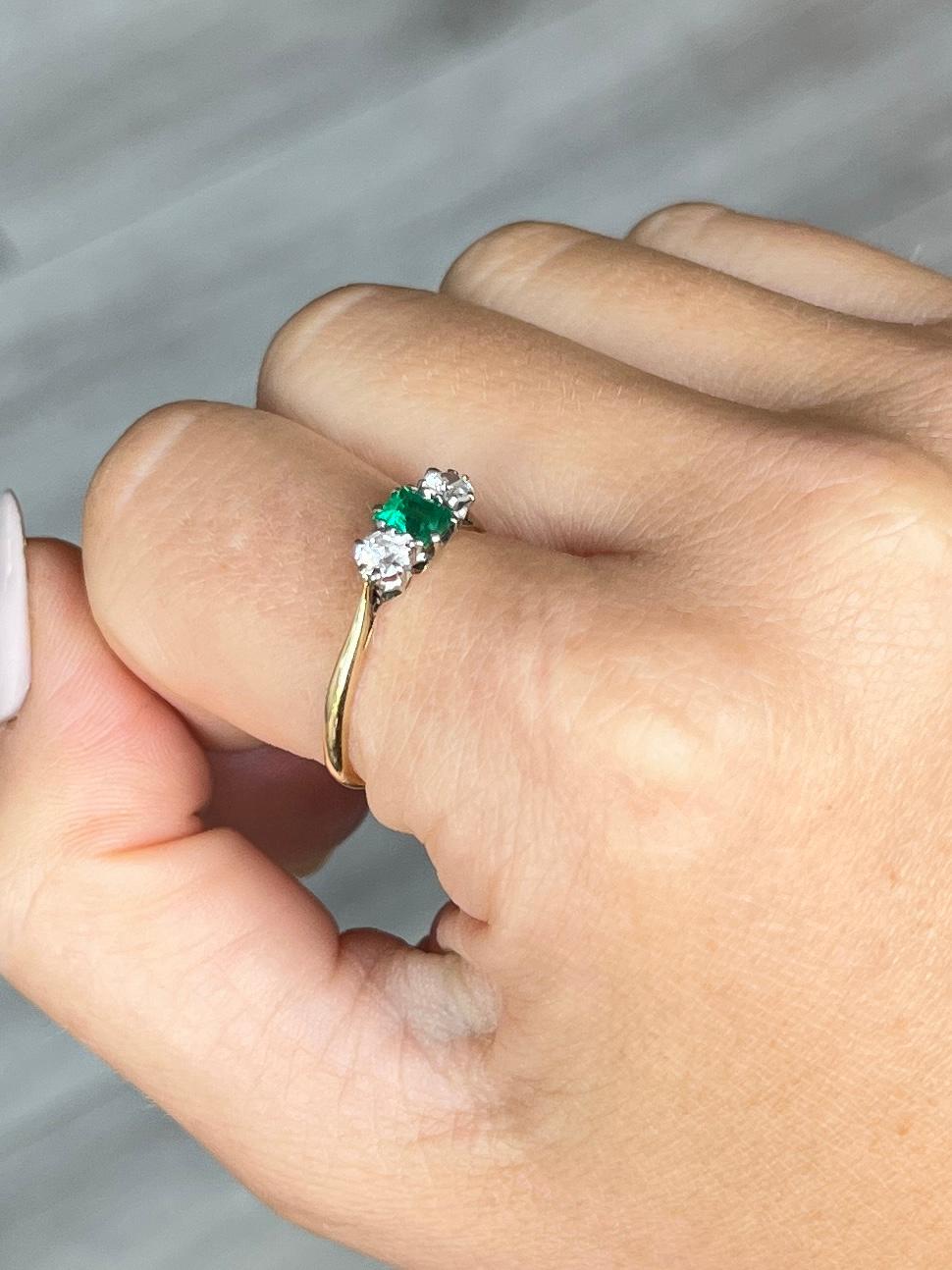 The central emerald is so bright and beautiful and measures 45pts. Sat either side it are two bright shimmering old European cut diamonds each measuring 15pts each. The ring is modelled in 18ct gold.

Ring Size: Q or 8 1/4 
Height Off Finger: