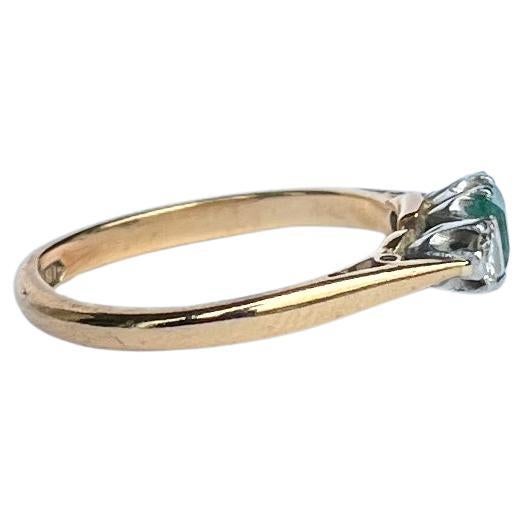 The central emerald is so bright and beautiful and measures 35pts. Sat either side it are two bright shimmering old European cut diamonds each measuring 7pts. The ring is modelled in 18ct gold.

Ring Size: K or 5 1/4 
Height Off Finger: 5mm

Weight: