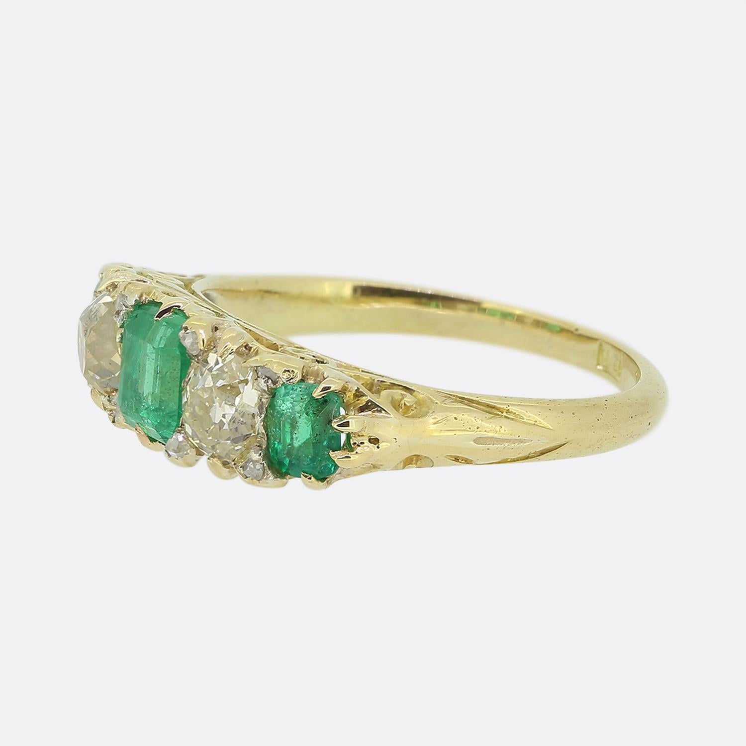 Here we have a classic 18ct yellow gold Edwardian five-stone ring. The piece showcases an alternating sequence of gem stones in a single line formation. An emerald cut natural emerald sits at the centre and is flanked on either side by a chunky old
