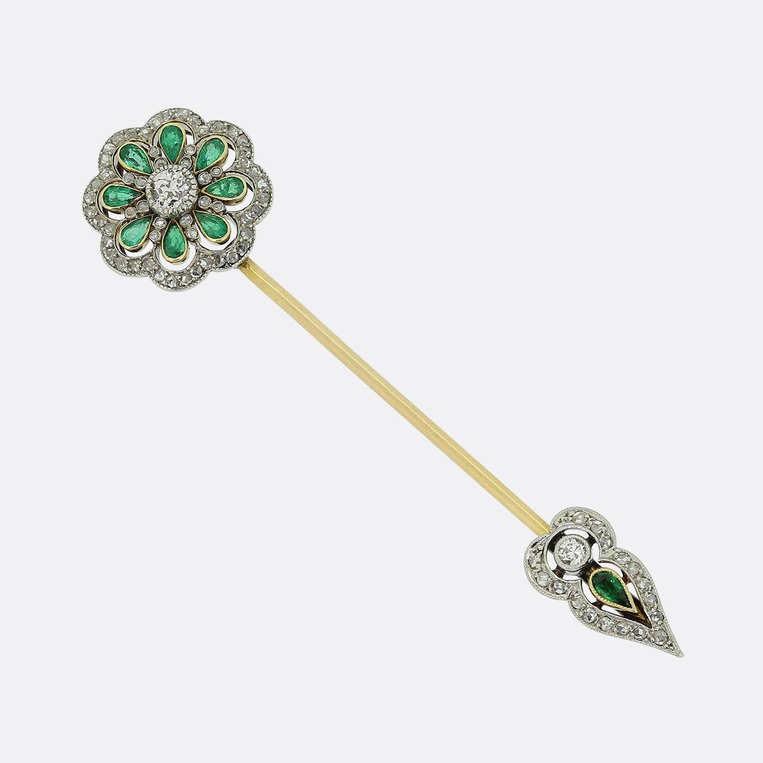 Here we have an antique emerald and diamond jabot pin. This piece was crafted from 18ct yellow gold during the early stages of the 20th century with the head showcasing a single old cut diamond at the centre surrounded by a cluster of pear shaped