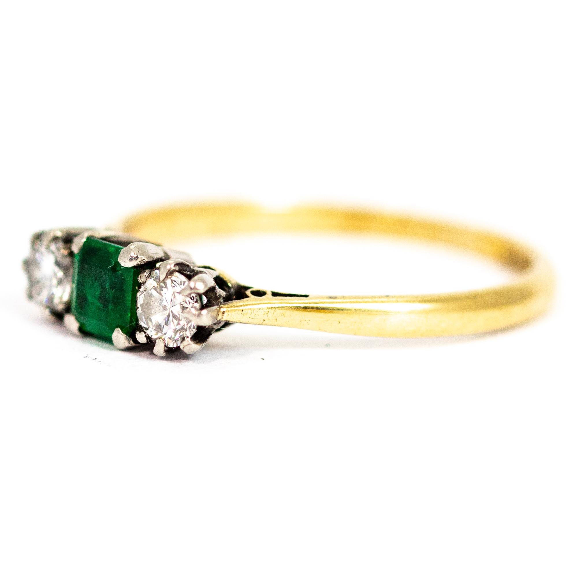 This there stone ring holds a square cut emerald at the centre which measures approximately .33pts. Either side of the beautiful bright green stone sit a sparkling diamond measuring approximately .15pts. The stones themselves are set in platinum and