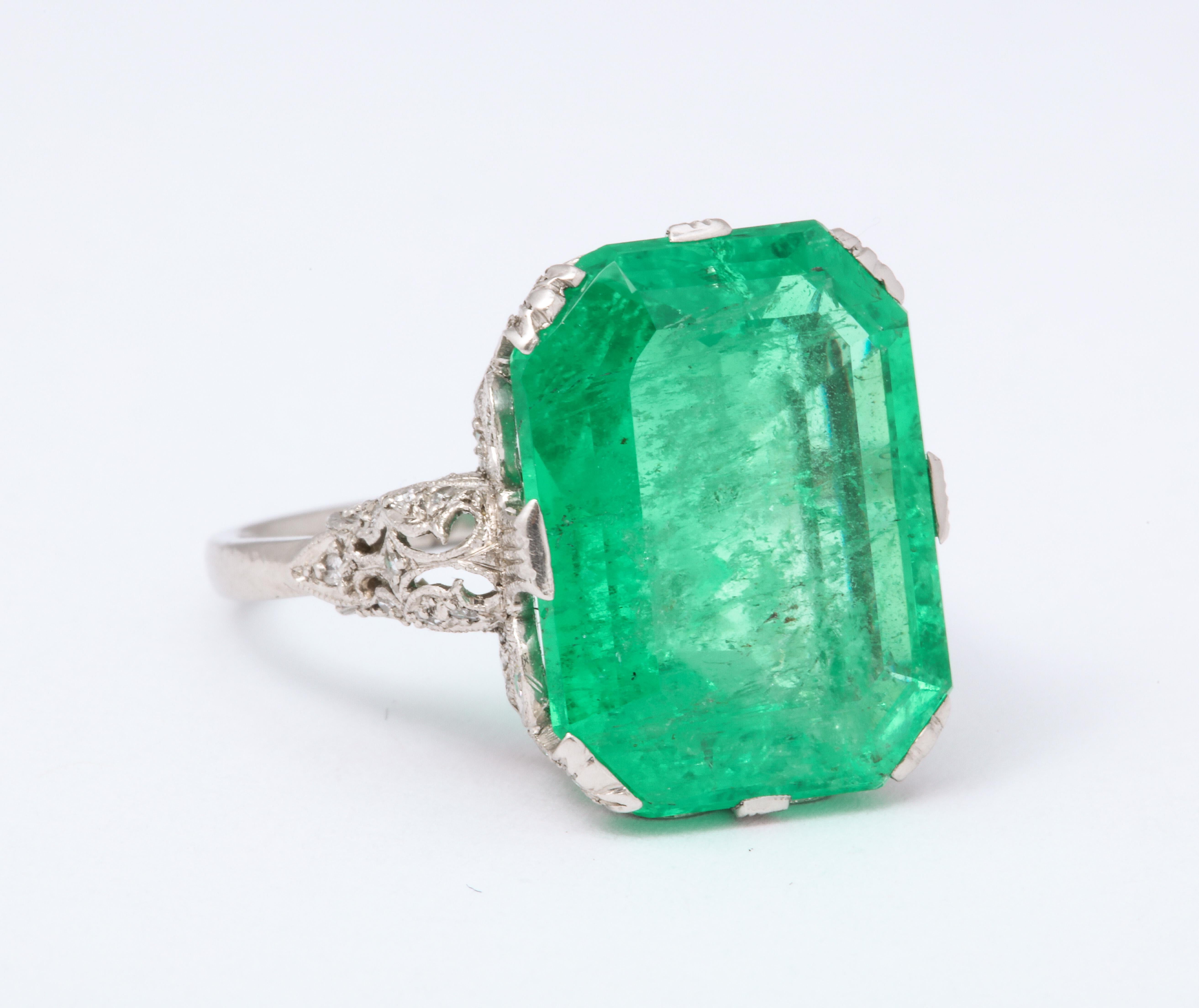 Emerald cut Edwardian Emerald Ring. Platinum unmarked but tested. 6.7 grams. Emerald @ approximately 9.0 cts tw, 54 single cut fine white diamonds @ .30 cts tw. Incredible lace-like gallery was handmade. Circa 1900. Size 5 1/4.