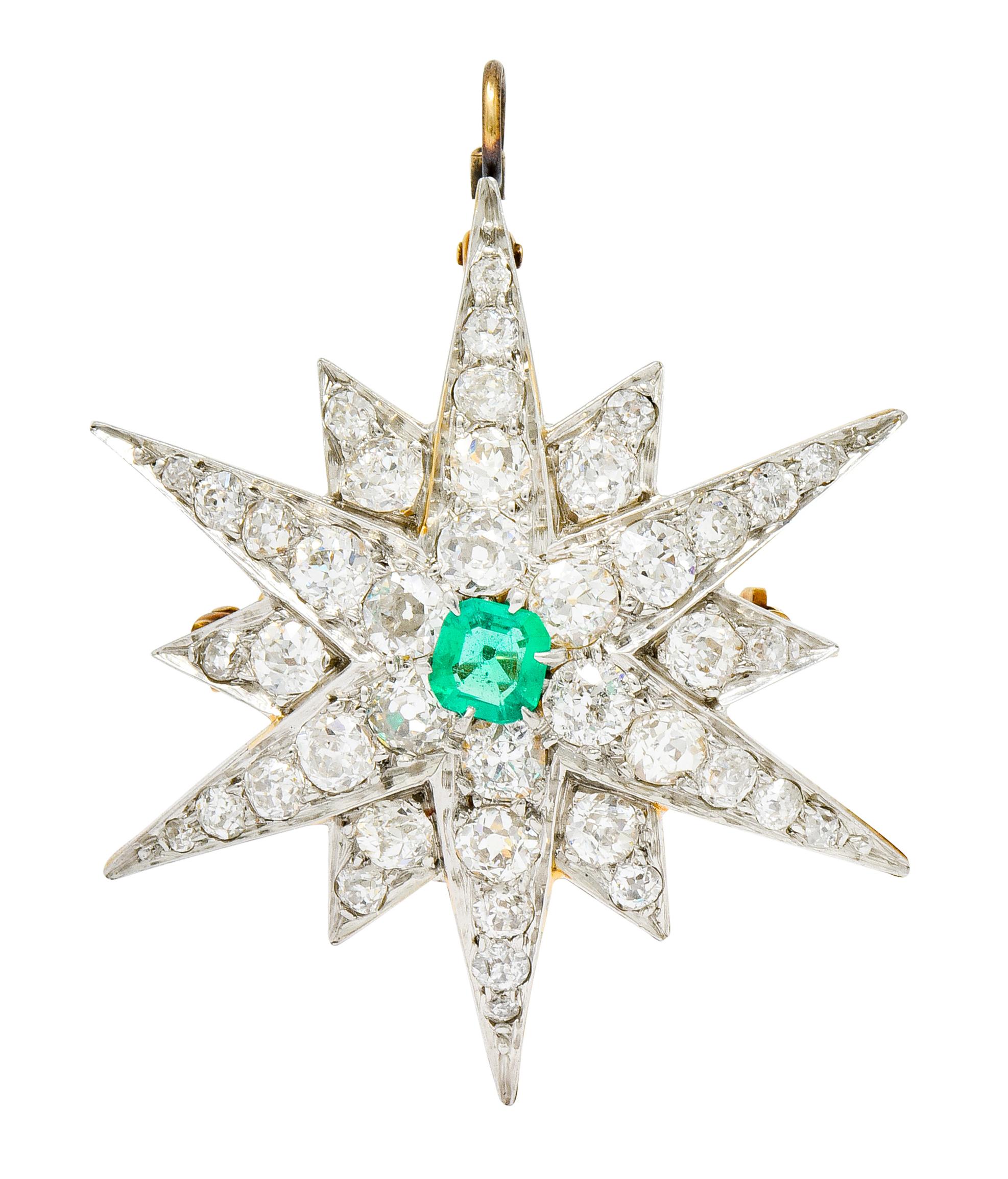 Pendant brooch designed as a radiating starburst motif with alternating long and short triangular rays

Centering an emerald cut emerald, bright transparent green in color, weighing approximately 0.40 carat

Surrounded by old European cut diamonds