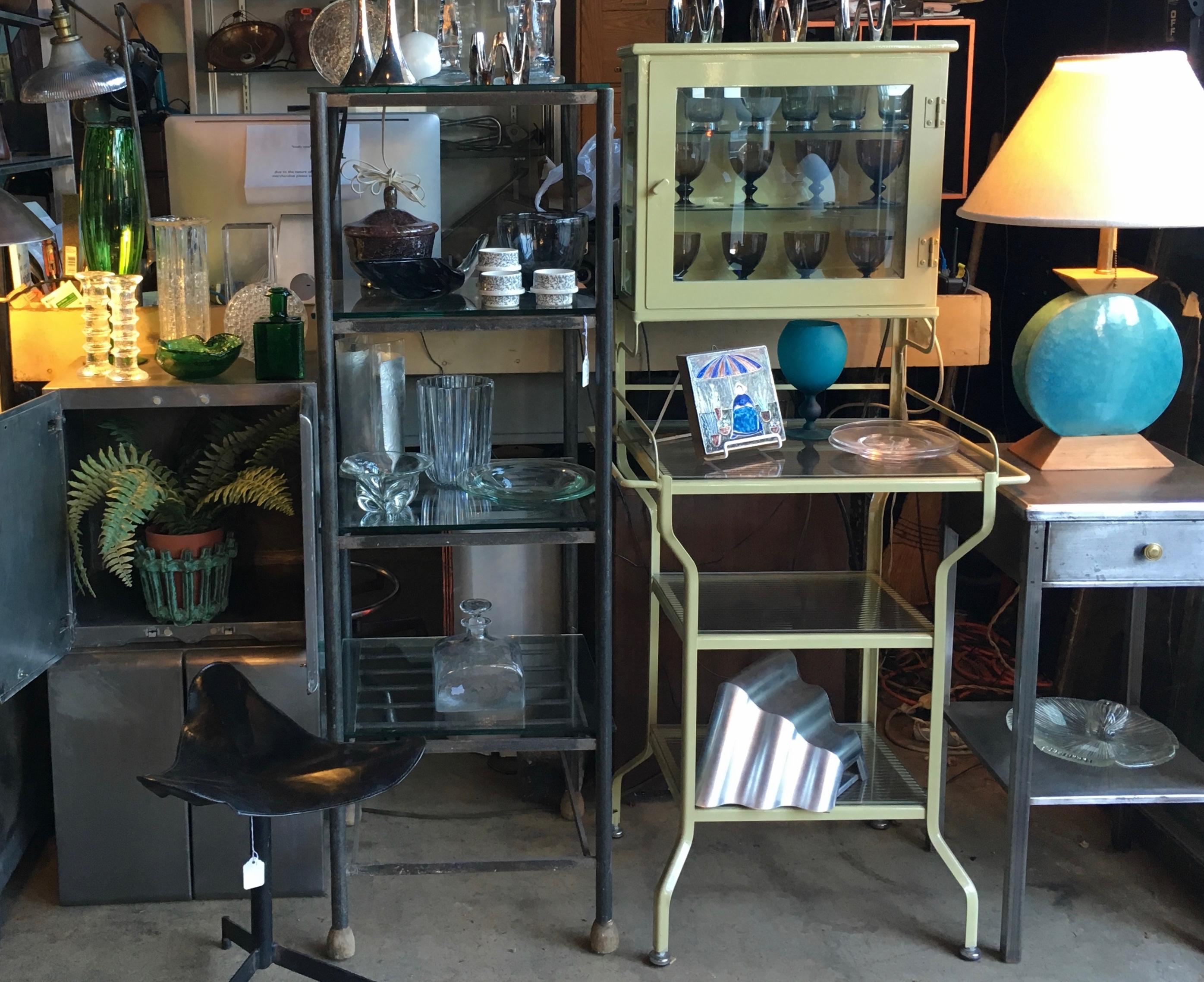 Early 20th Century Enclosed Set Back Medical Cabinet with five Clear Glass shelves. Featuring a Pale Green enameled steel framework, beveled upper glass door, 2 rectangular clear glass side panels, three lower original optical glass shelves, 2 towel