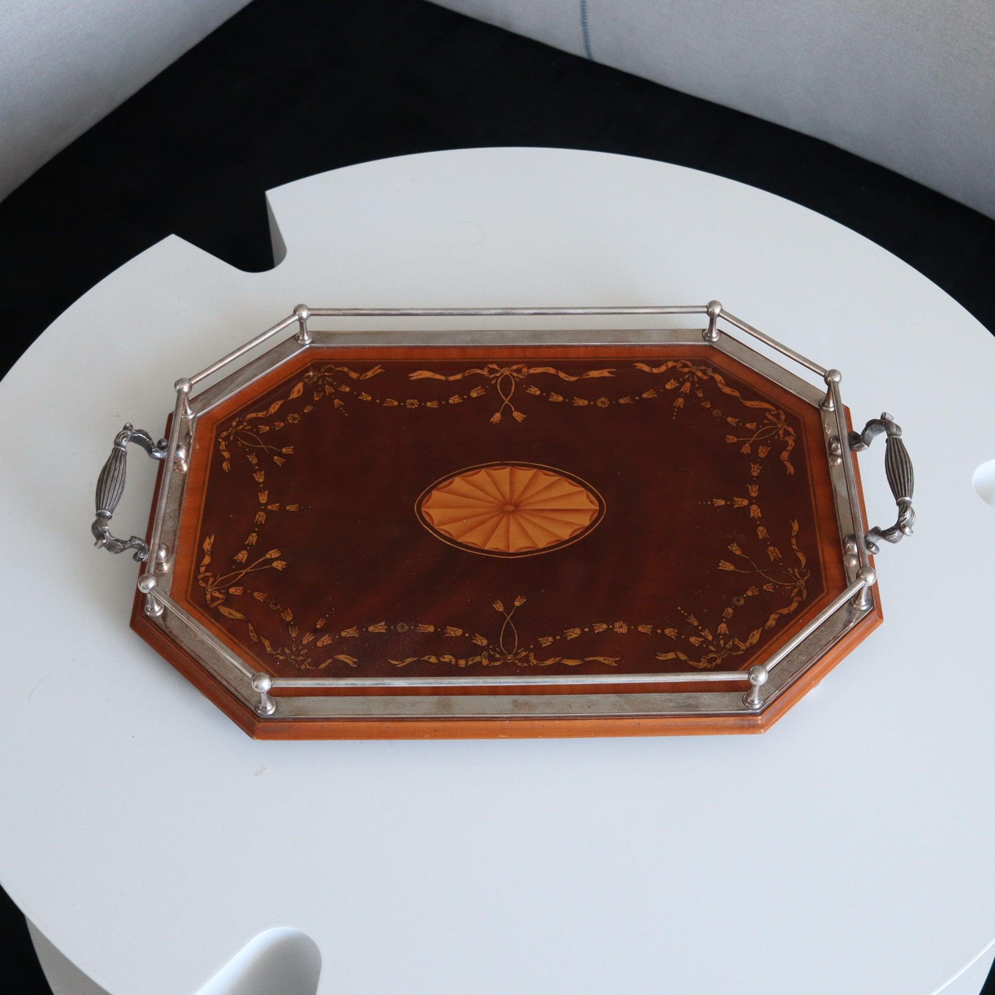 An England serving tray from the Edwardian Period.

This is a fabulous continental large serving tray created in England during the Edwardian period, back in the 1900's. The tray has been crafted with neoclassical patterns with parts made up in