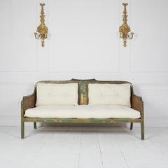 Edwardian English chinoiserie painted green caned sofa