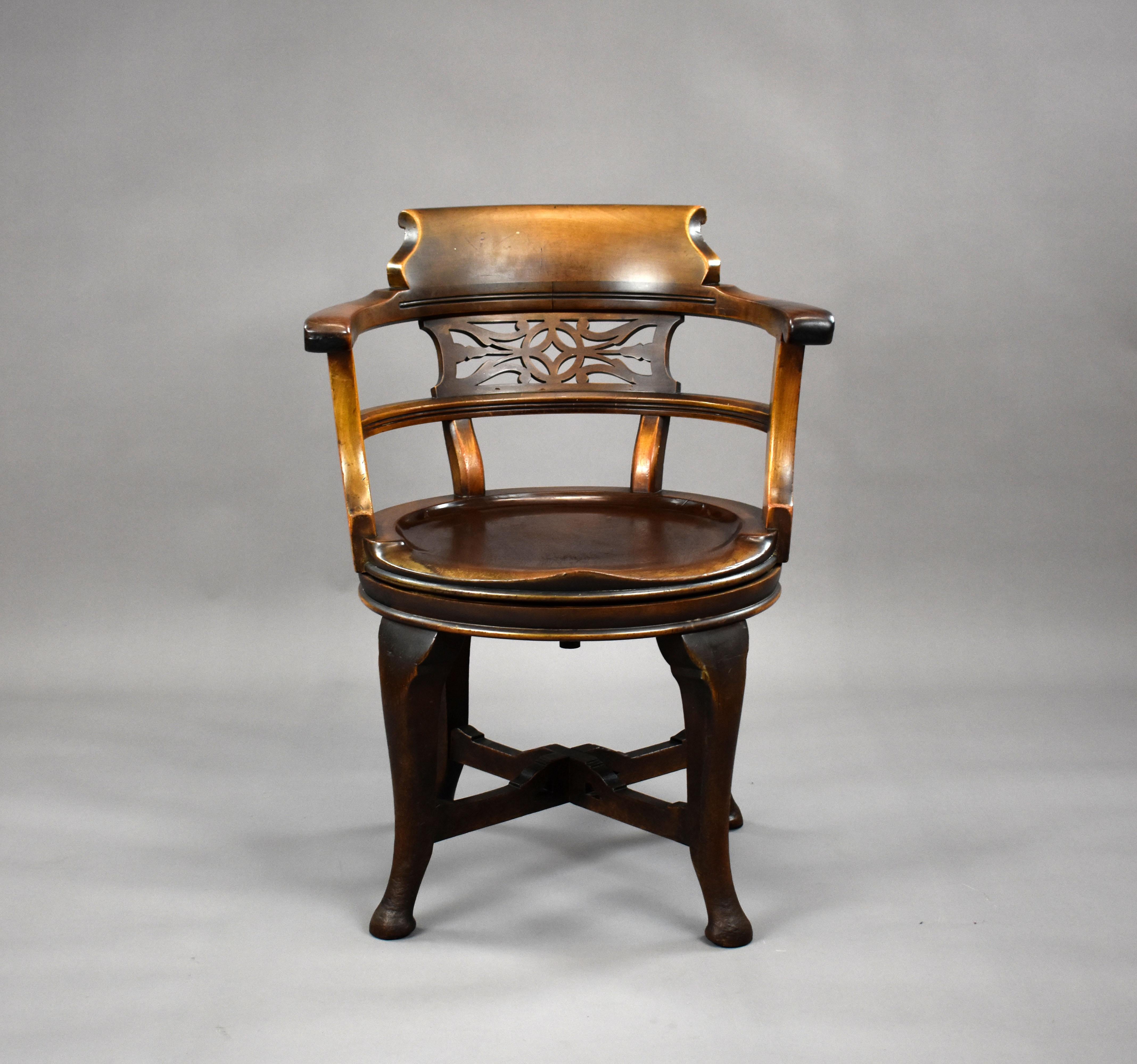 For sale is a good quality Edwardian mahogany revolving desk chair, with a bowed back centred by a pierced panel above a saddle seat. The chair stands on cabriole legs united by an x stretcher. The chair remains in good condition for its age showing