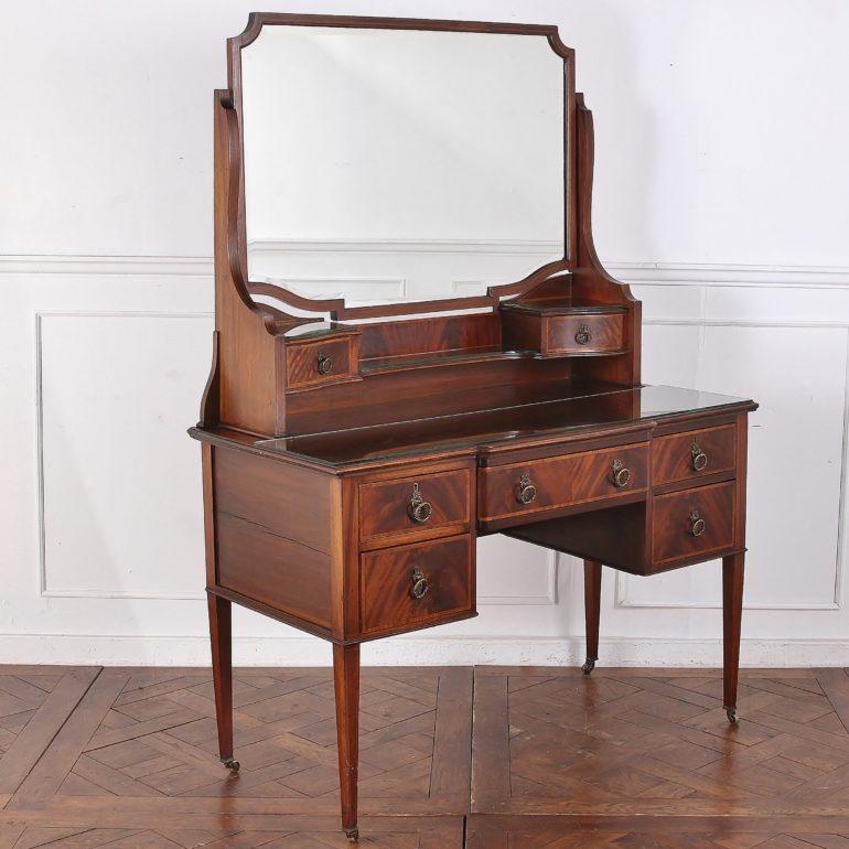English, solid mahogany inlaid Edwardian vanity and mirror, with original brass drawer pulls and casters.



 