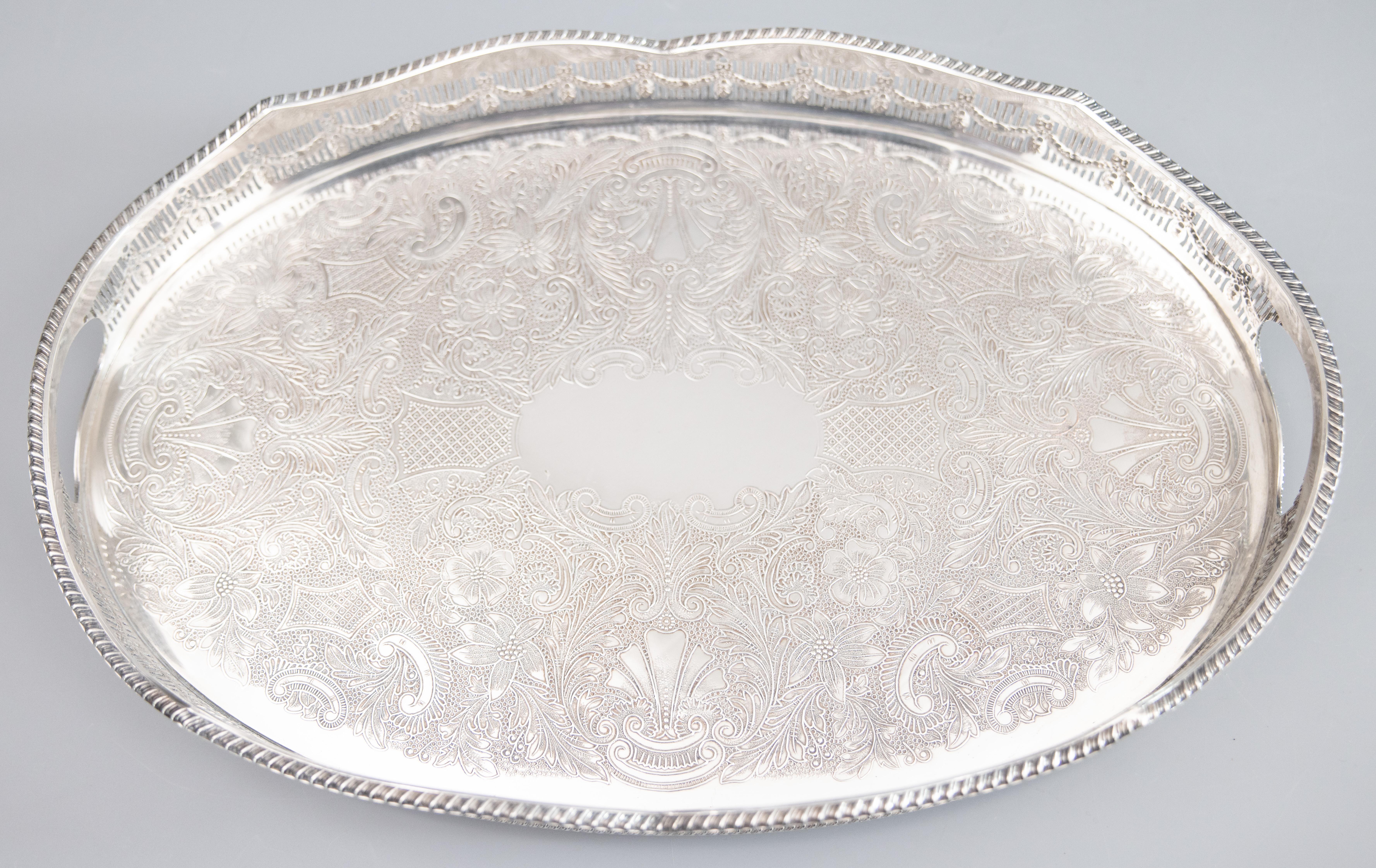 A fine antique early 20th-Century English silverplate footed gallery serving or barware tray with handles. Marked 