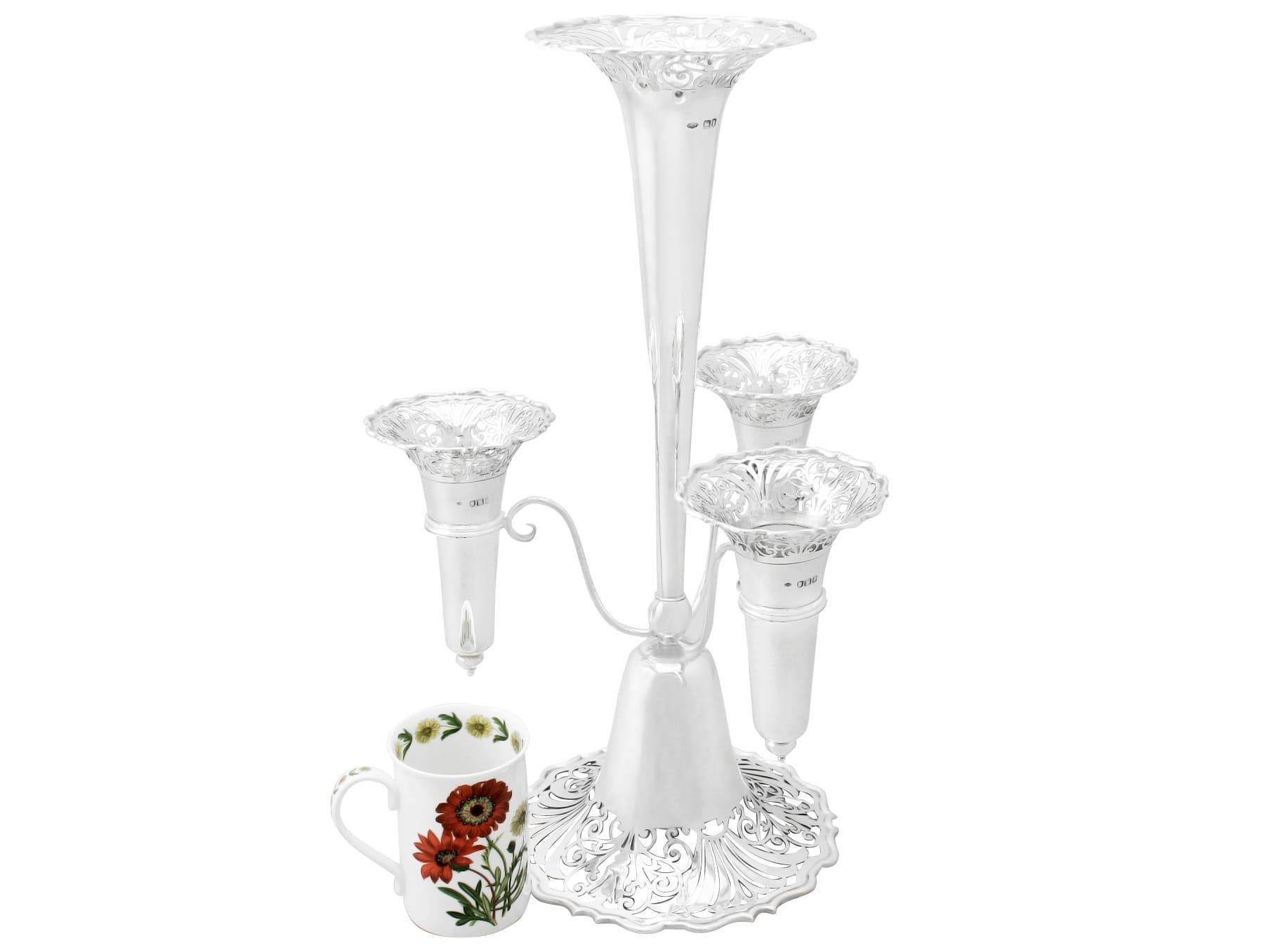 A fine and impressive antique Edwardian English sterling silver epergne or centerpiece; part of our ornamental silverware collection.

This antique Edwardian sterling silver epergne or centerpiece has a plain, tapering form with a flared rim onto a