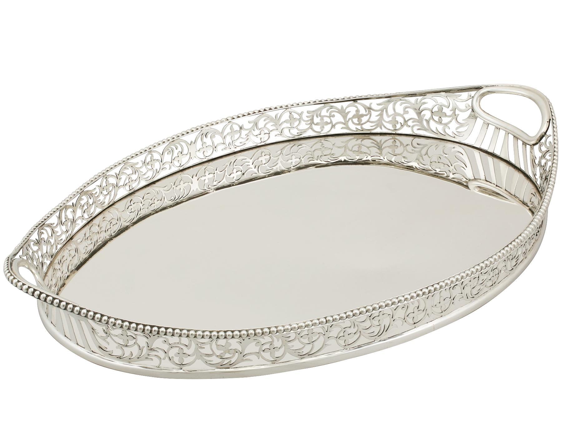 An exceptional, fine and impressive antique Edwardian English sterling silver galleried drinks tray made by Charles Stuart Harris; an addition to our Edwardian teaware collection.

This exceptional antique Edwardian sterling silver drinks tray has a