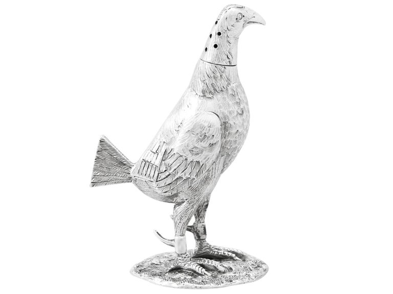 A fine and impressive antique Edwardian English sterling silver pepperette realistically modelled in the form of a game bird; an addition to our range of silver novelty items

This exceptional antique Edwardian sterling silver pepperette has been